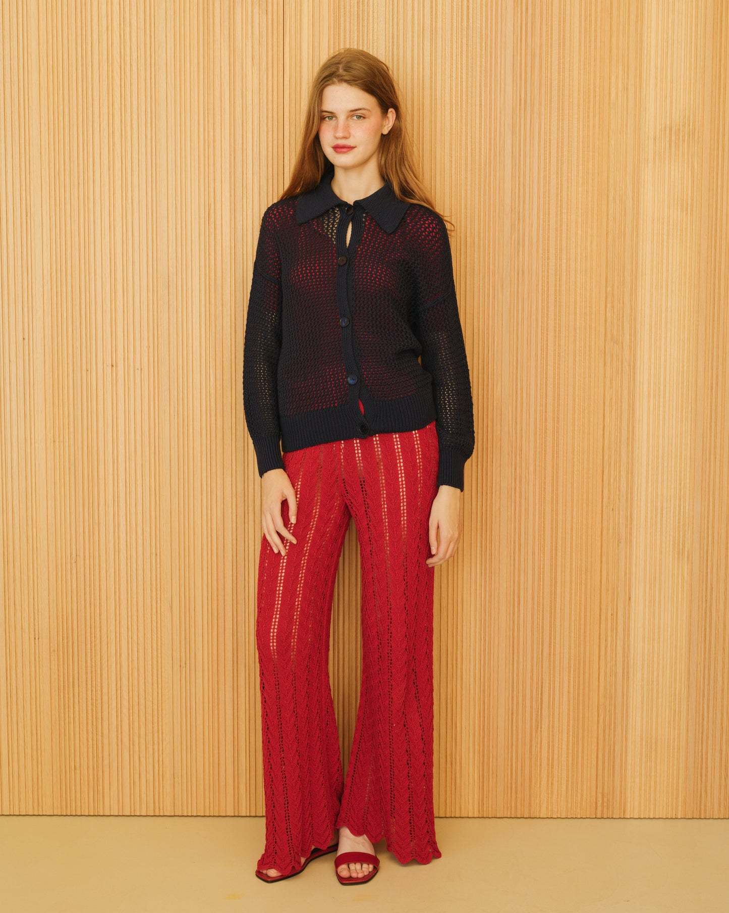 Navy Fine Cotton Crochet Polo Cardigan by Lèmme paired with red crochet pants. Italian luxury cotton knitwear with breathable openwork design.