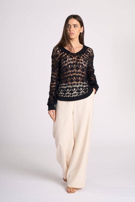 Model walking in navy Crochet Cotton Top - Elisa by Tenné, featuring 100% cotton open-knit design and relaxed fit for elegant summer outings.