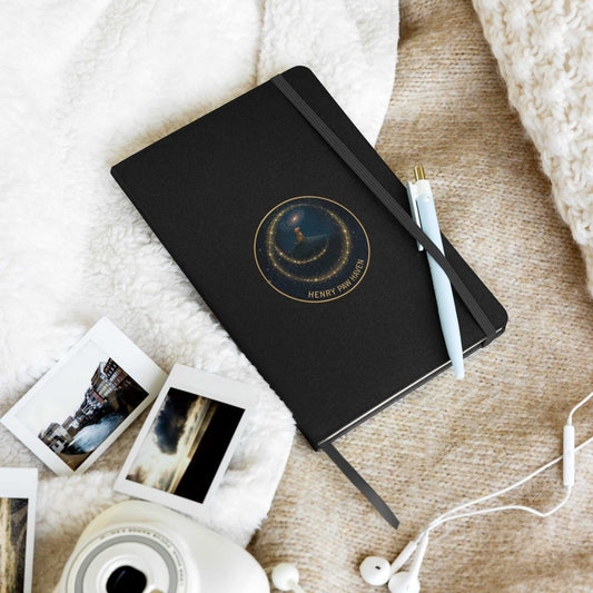 Black Hardcover Bound Notebook 5.5" × 8.5" with 80 lined pages and HenryPawHaven logo, placed on cozy blanket with pen and photos.