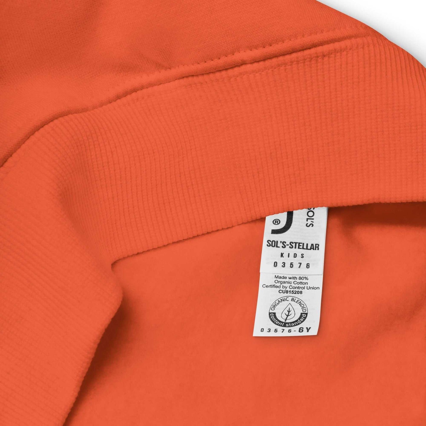 Interior label of orange organic cotton kids hoodie with certification tag, confirming eco-friendly and sustainable fabric choice.