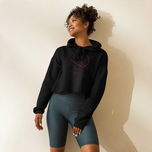 Love Laughing Women's Cropped Hoodie in black with red heart design, styled for Valentine's Day. Eco-friendly cotton blend, perfect for casual wear.