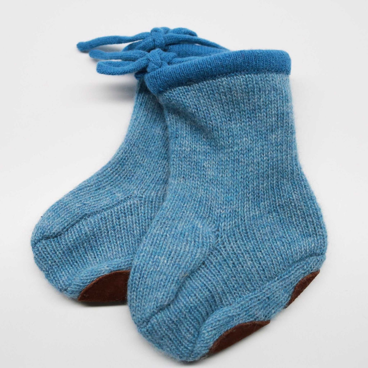 Portolano Baby Cashmere Booties in blue featuring suede soles and knit ties. Heirloom-quality baby footwear perfect for 0-12M infants.