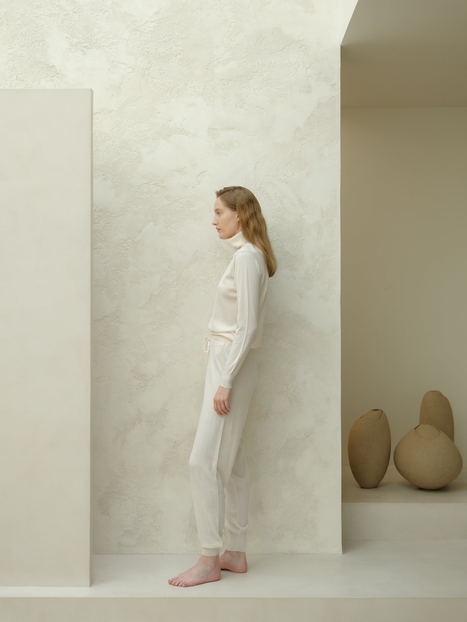 Side view of ivory Extra Fine Merino Yoga Pants by Lèmme. Elegant and breathable Italian knit activewear pants.