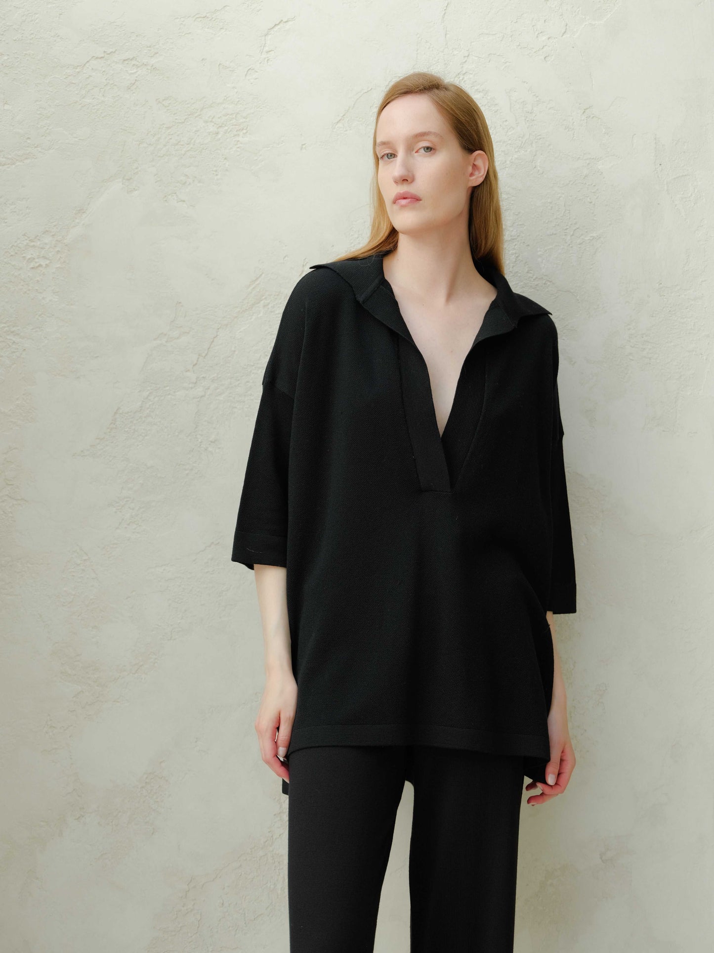 Extra Fine Merino Wool Maxi Polo in black with relaxed fit and deep V-neck, part of sustainable knitwear collection for timeless fashion.