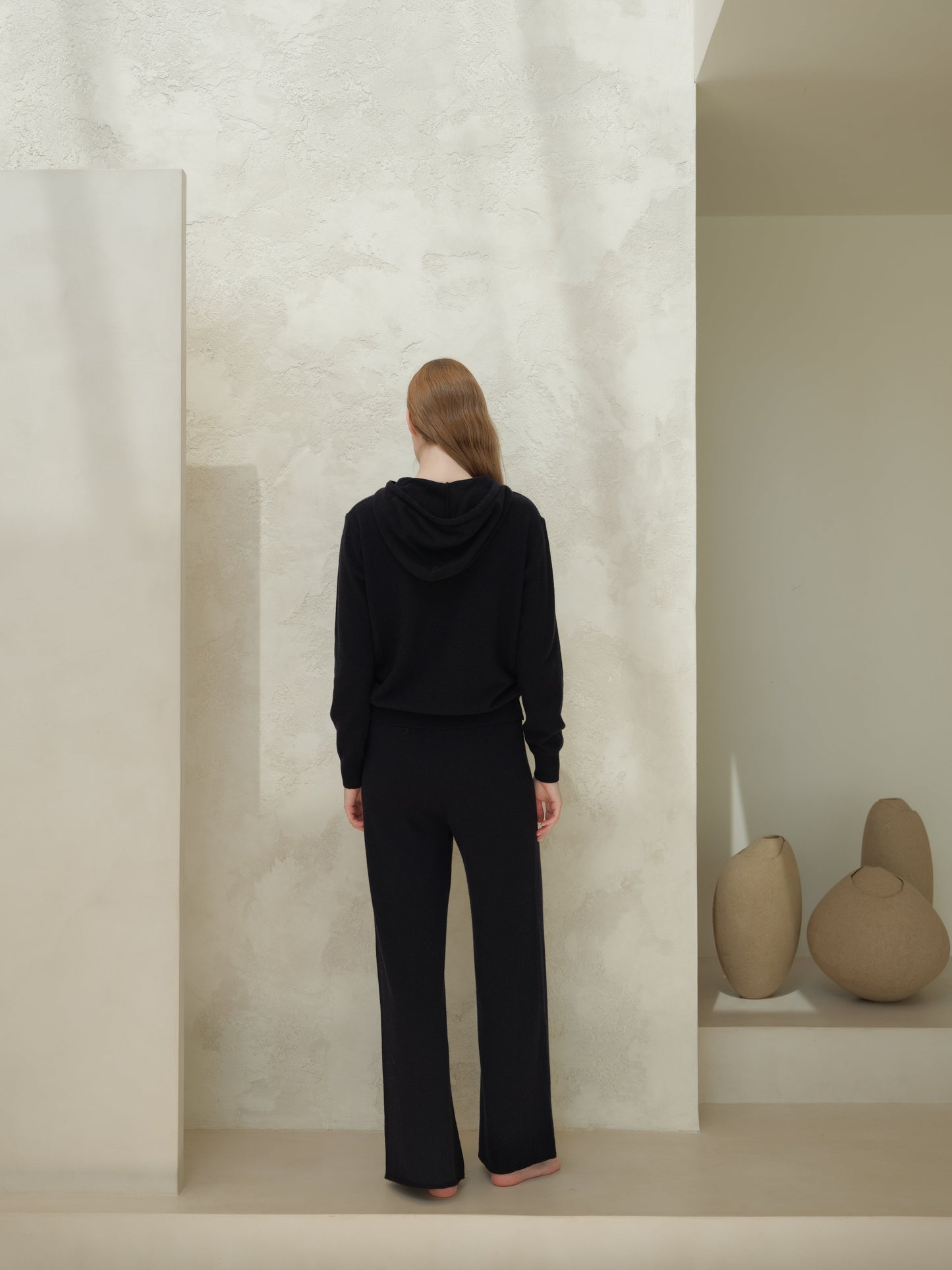 Back view of black 3D Cashmere Mix Wide Legged Light Pants by Lèmme, Italian knitwear with seamless wool-cashmere design for timeless elegance.