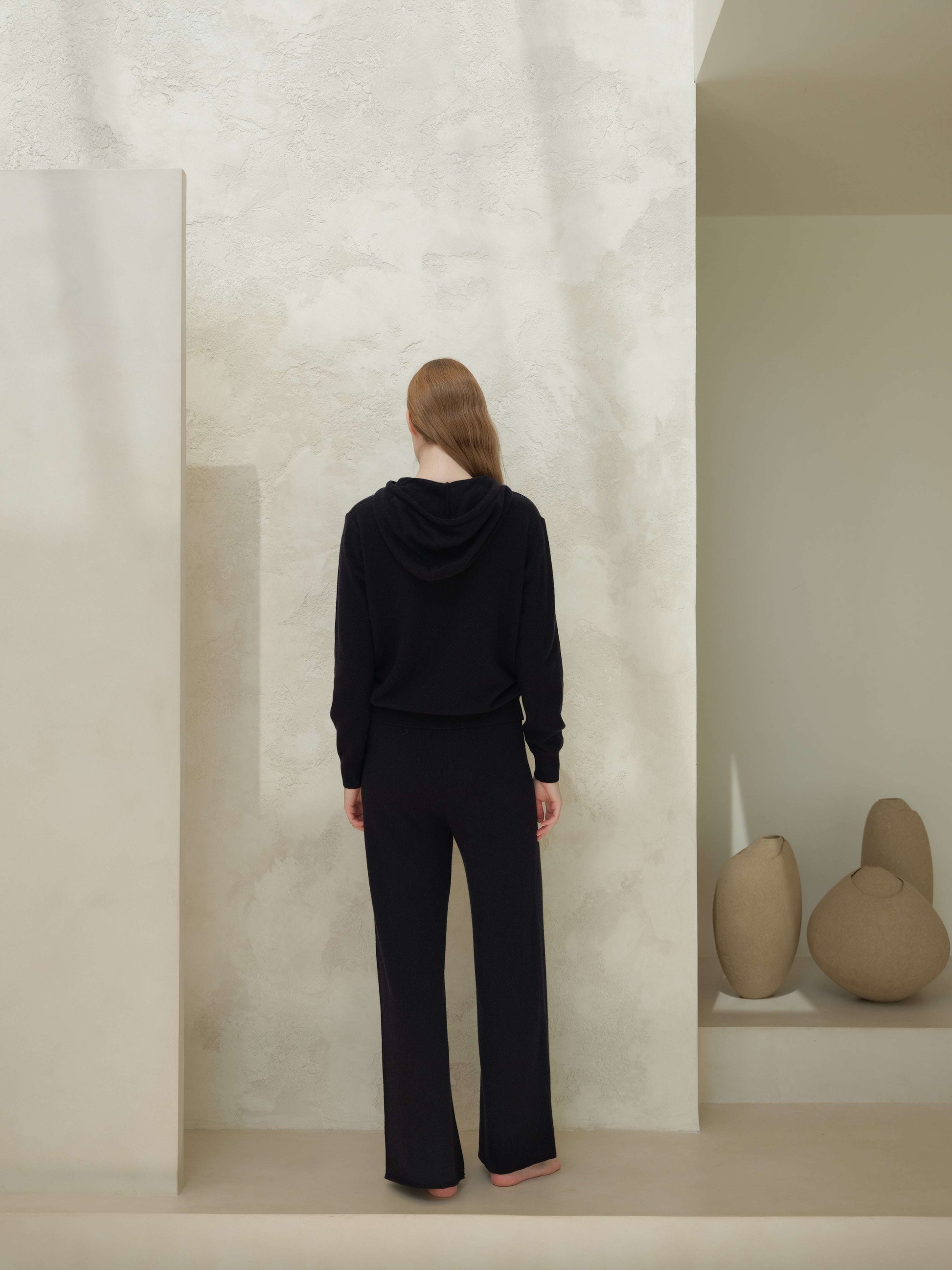 Back view of black 3D Cashmere Mix Wide Legged Light Pants by Lèmme, Italian knitwear with seamless wool-cashmere design for timeless elegance.