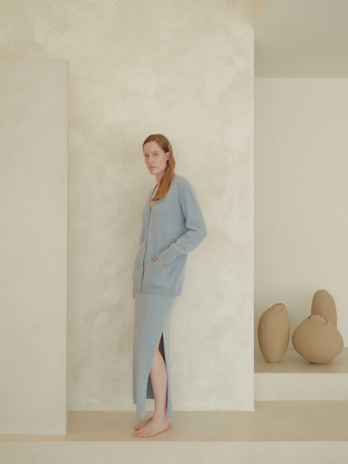 Light blue cashmere skirt with side slit and matching cardigan. Premium Italian knitwear crafted for softness and minimalist style.