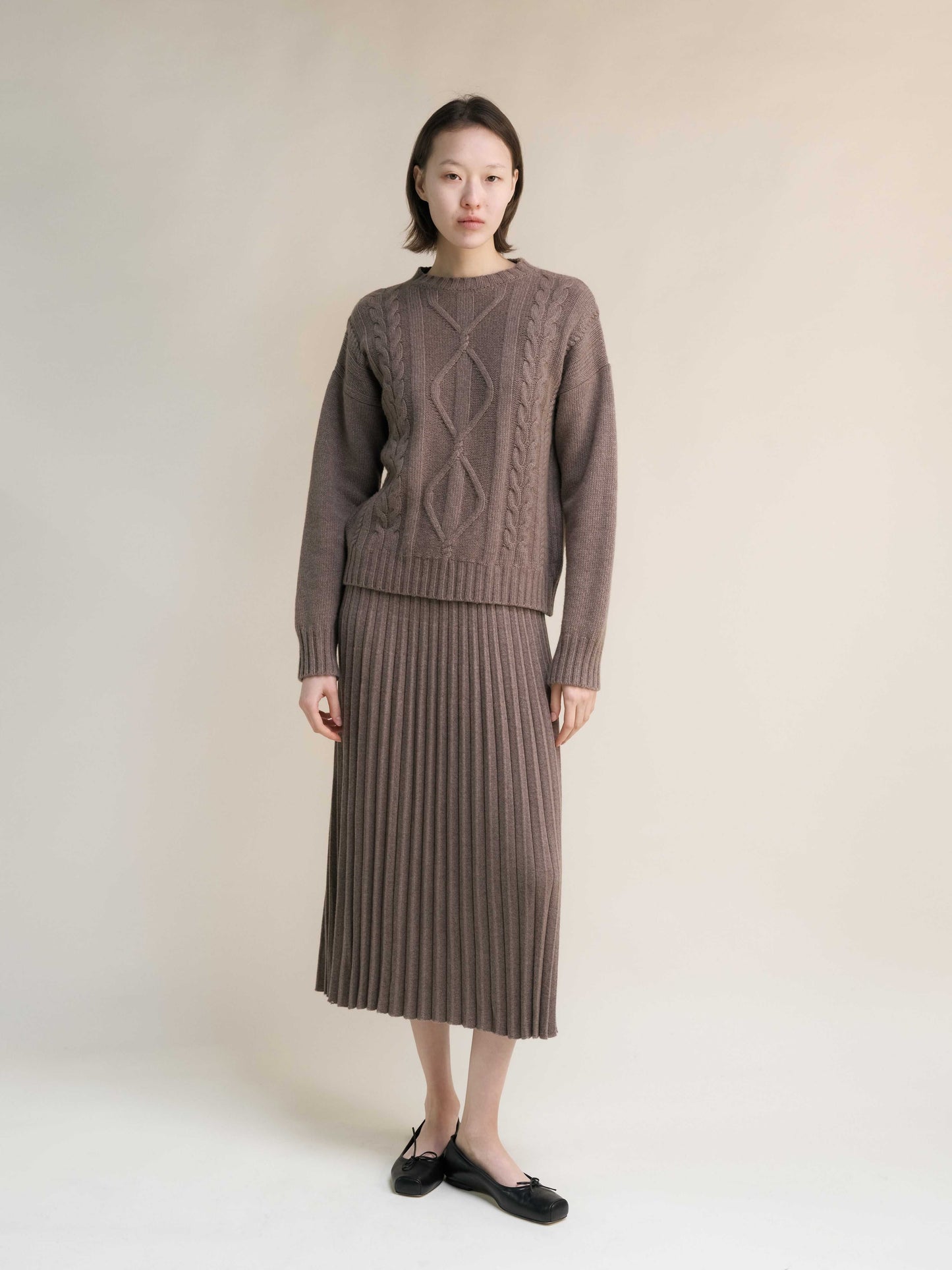 Full outfit featuring taupe Cashmere Mix Cable Knit Sweater and ribbed skirt. Sustainable Italian knitwear from HenryPawHaven for chic comfort.