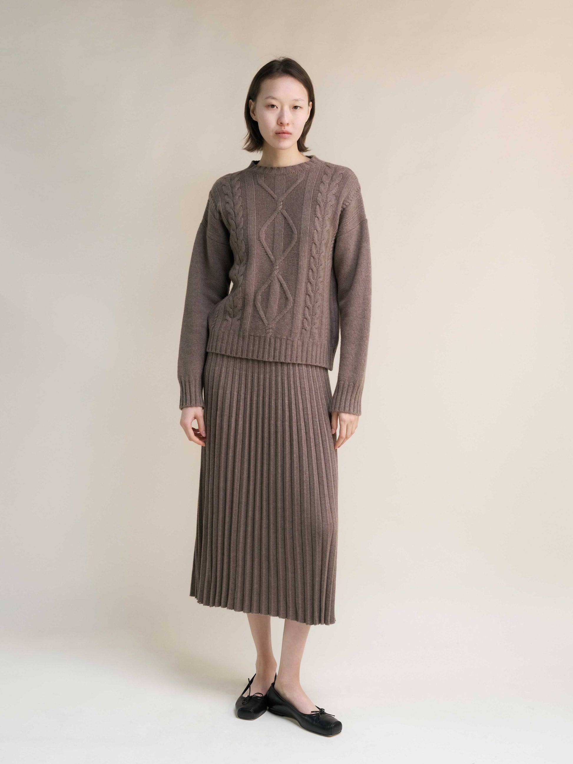 Full outfit featuring taupe Cashmere Mix Cable Knit Sweater and ribbed skirt. Sustainable Italian knitwear from HenryPawHaven for chic comfort.
