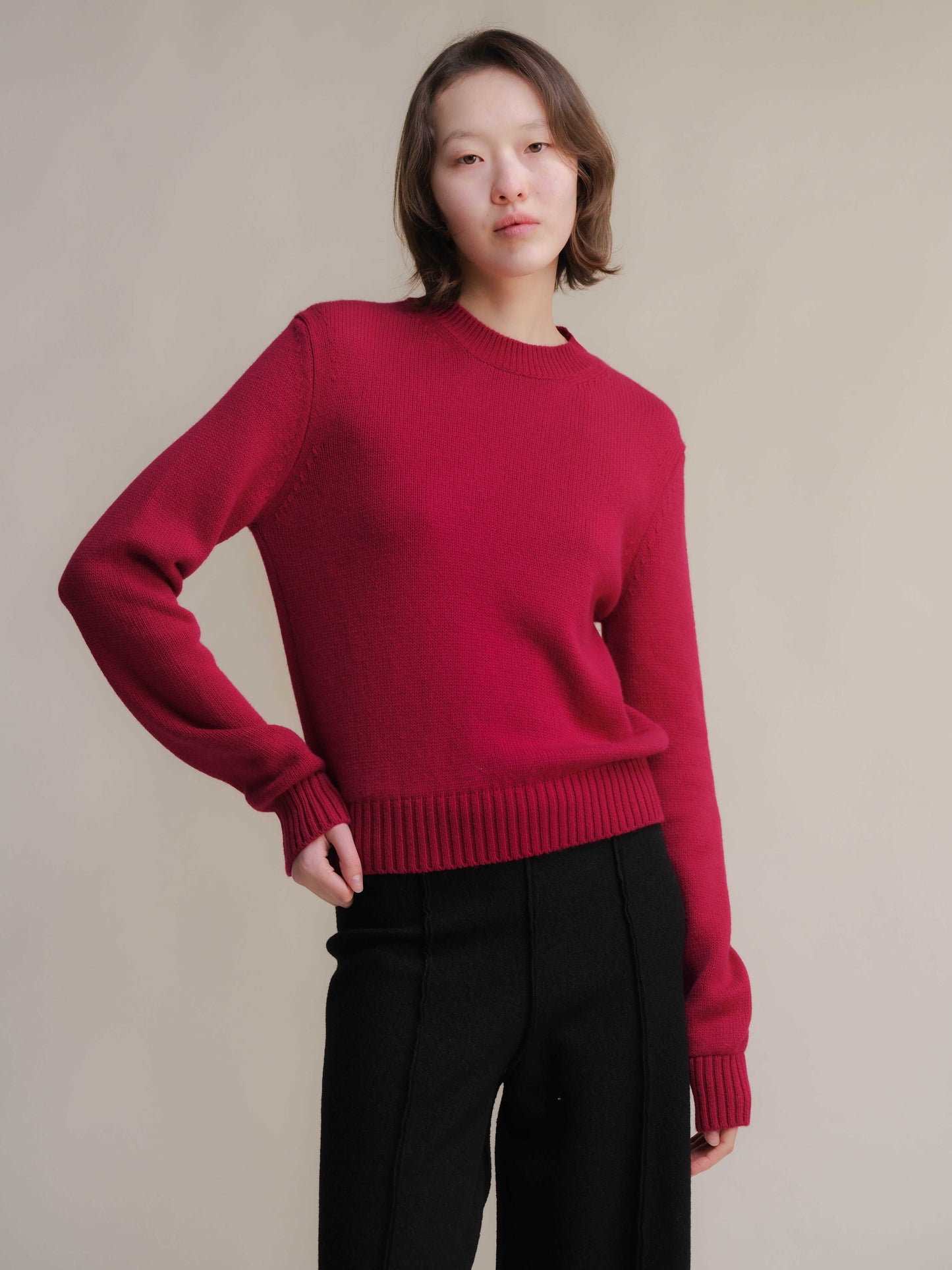 Pure Cashmere Crewneck Sweater in rich red paired with black trousers. Elegant Italian-made luxury knitwear by Lèmme at HenryPawHaven.