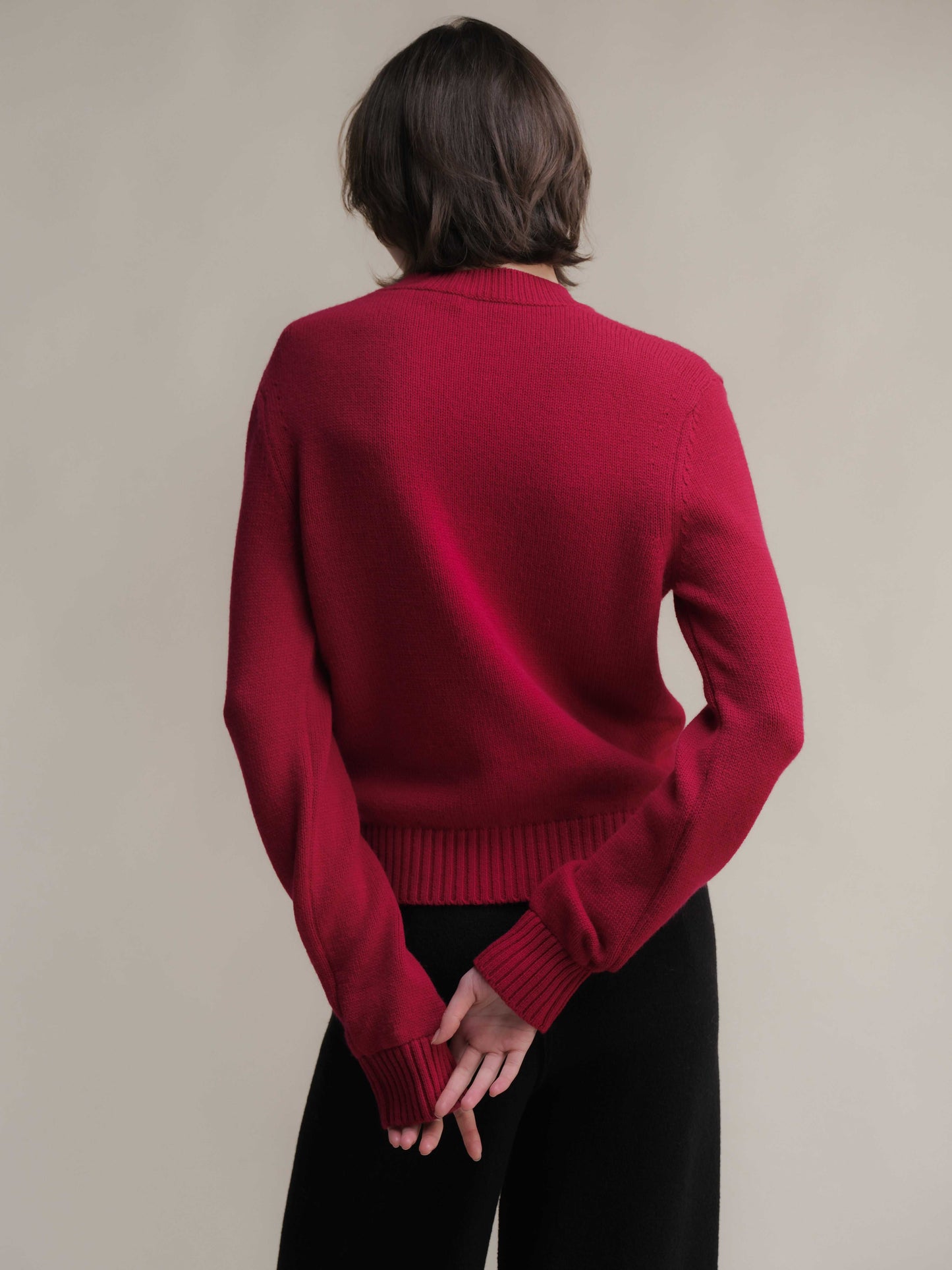 Back view of red Pure Cashmere Crewneck Sweater showing ribbed hem and cuffs. Italian-crafted luxury sweater by Lèmme.