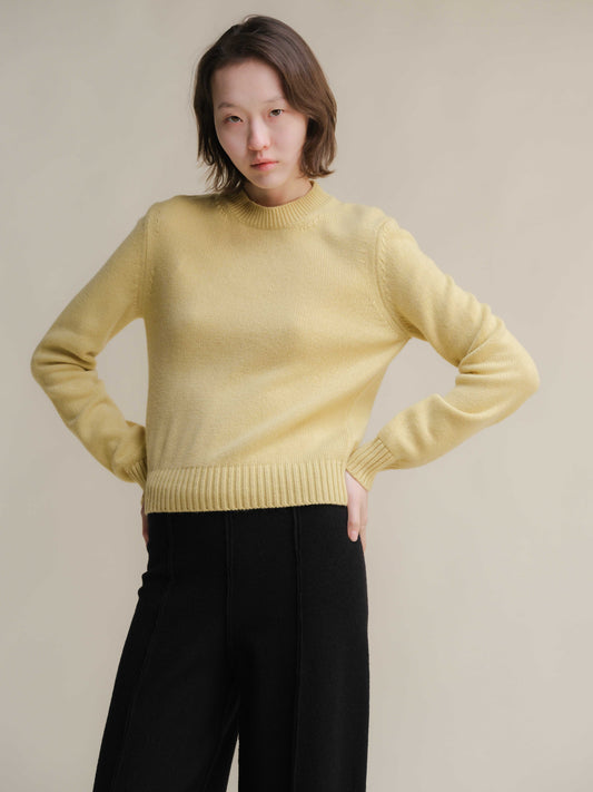 Pure Cashmere Crewneck Sweater in yellow styled with black pants. Premium Italian-crafted knitwear from HenryPawHaven by Lèmme.