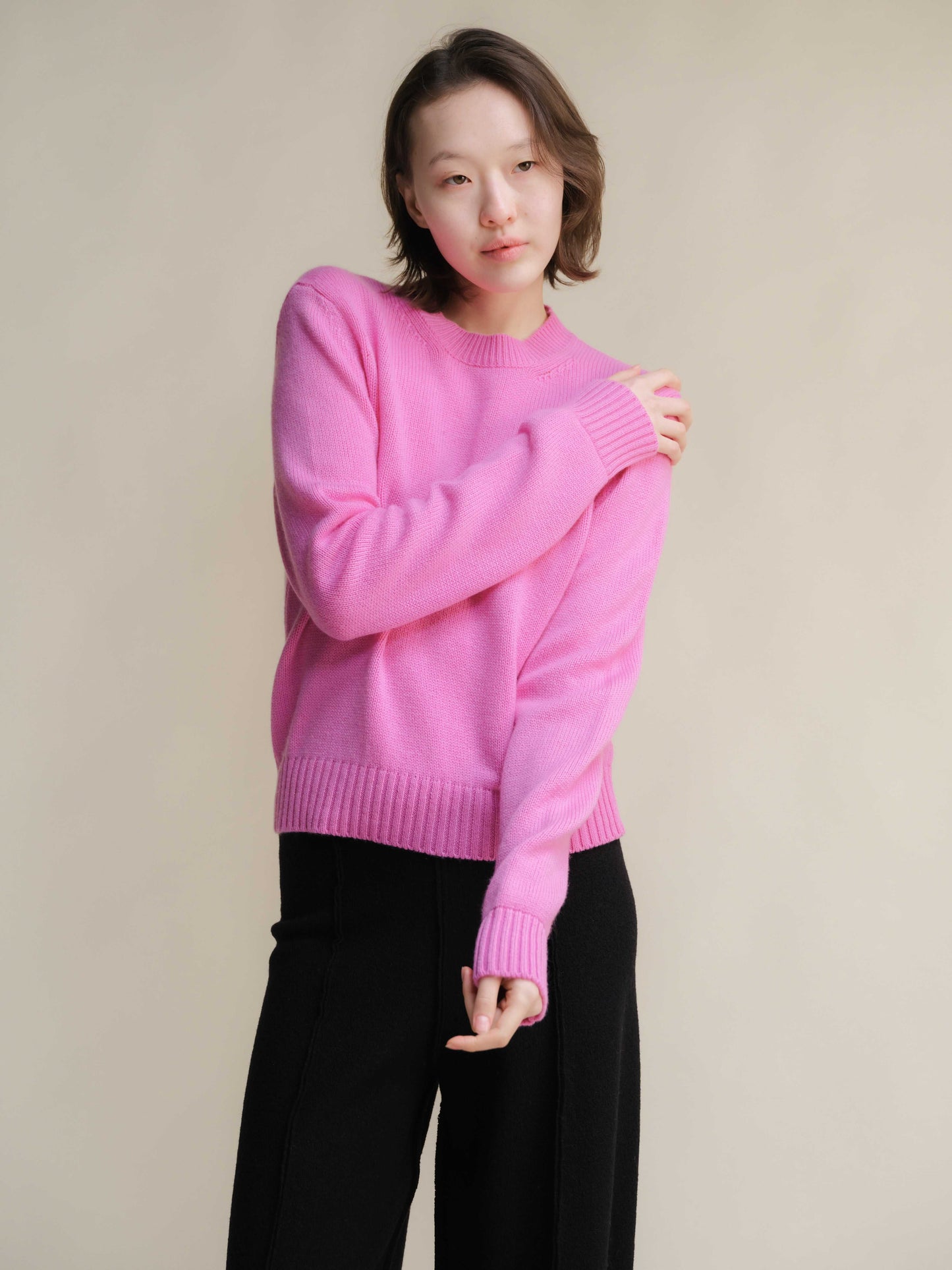 Vibrant pink Pure Cashmere Crewneck Sweater styled with black trousers. Soft, luxurious knitwear by Lèmme for HenryPawHaven.