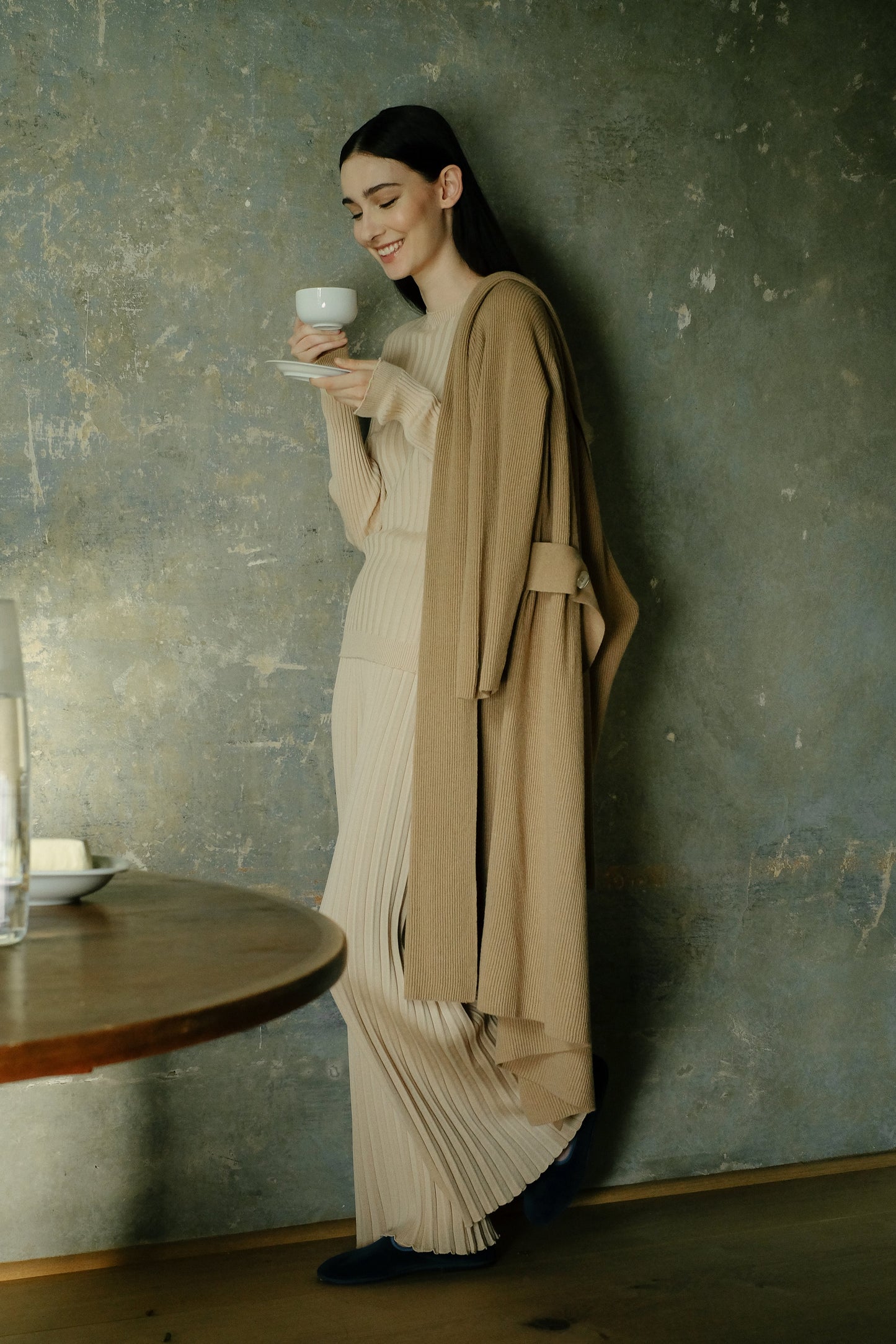 Model in camel Cashmere Mix Shawl-Collar Maxi Ribbed Cardigan enjoying coffee, styled with matching ribbed knitwear for a cozy chic look.