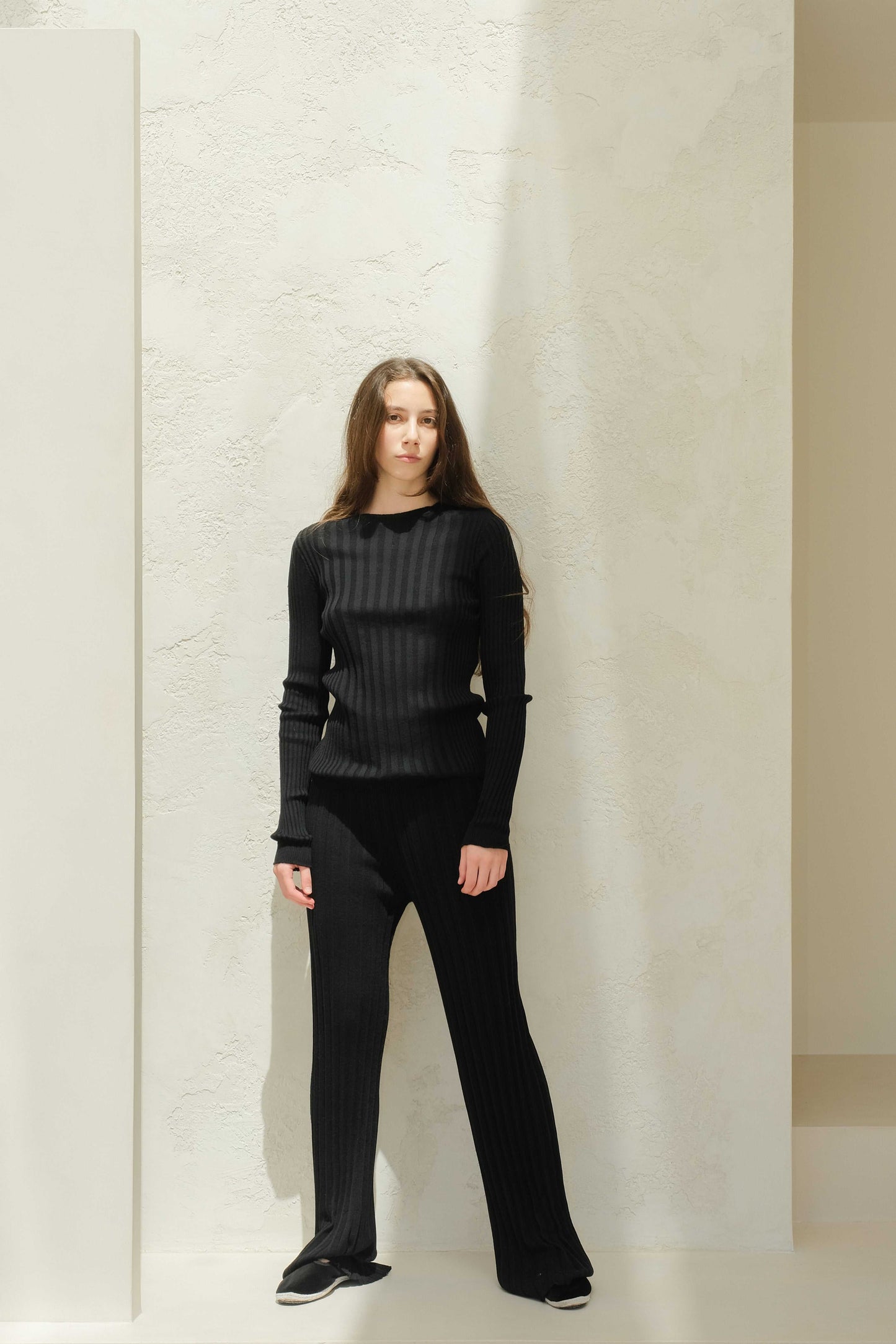 Full-body view of black Extra Fine Merino Wool Ribbed Crew Neck 3D-Knit Sweater, slim-fit knitwear ideal for layering and comfort.