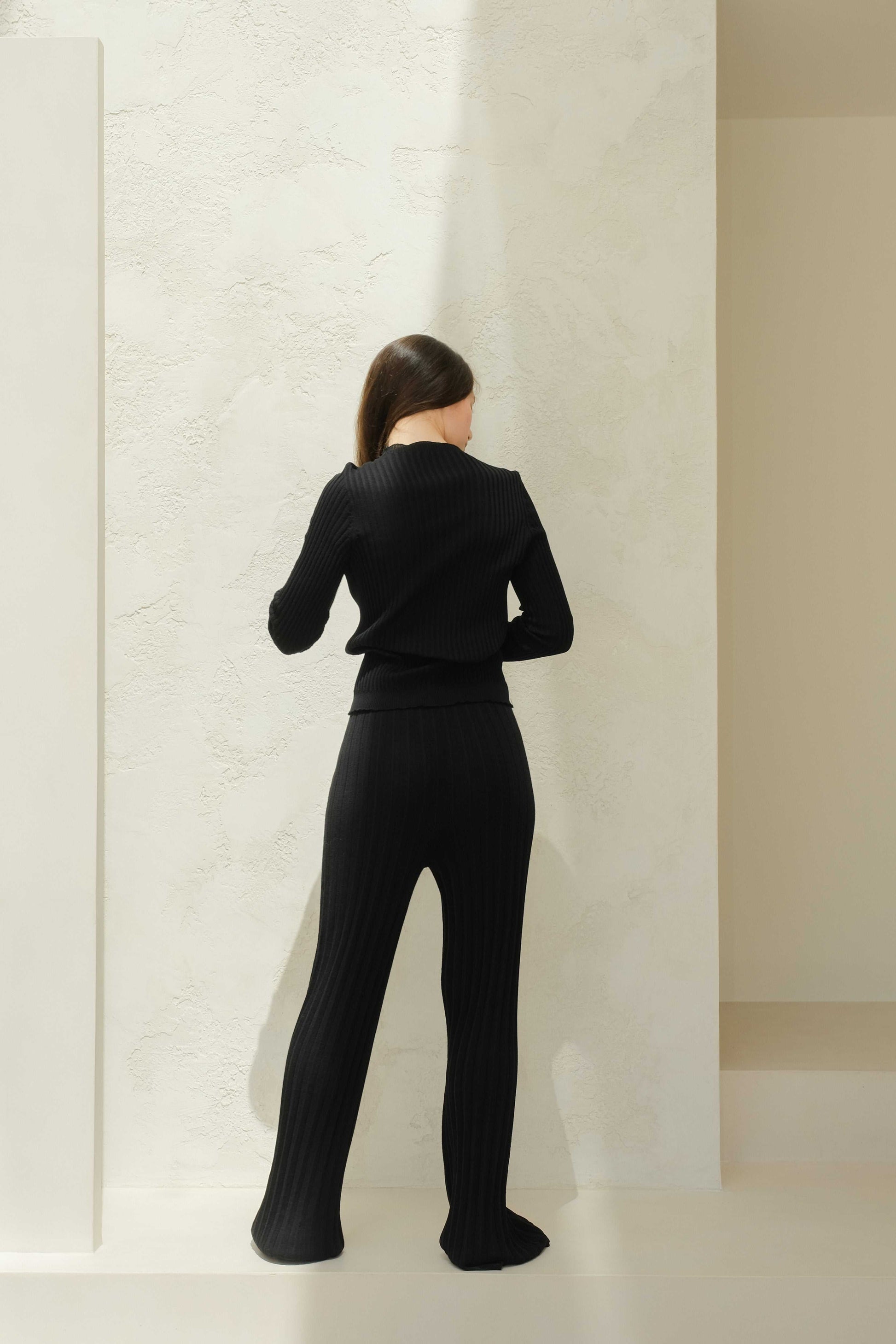 Back view of black Extra Fine Merino Wool Ribbed Crew Neck 3D-Knit Sweater, showcasing seamless 3D-knit construction and ribbed texture.