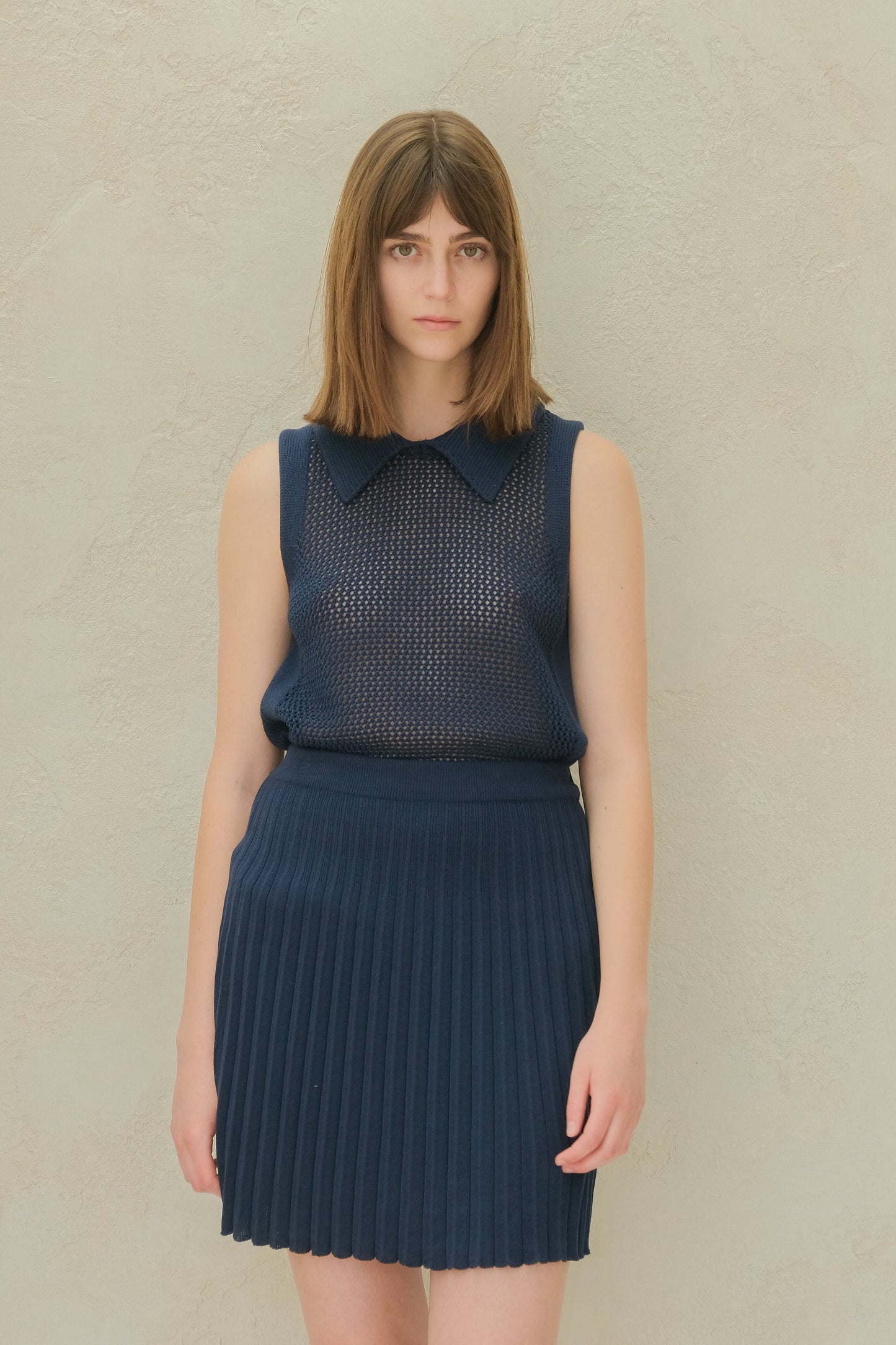 Fine Crochet Polo Tank Top in navy blue with matching pleated skirt. Elegant Italian merino wool knitwear from HenryPawHaven.