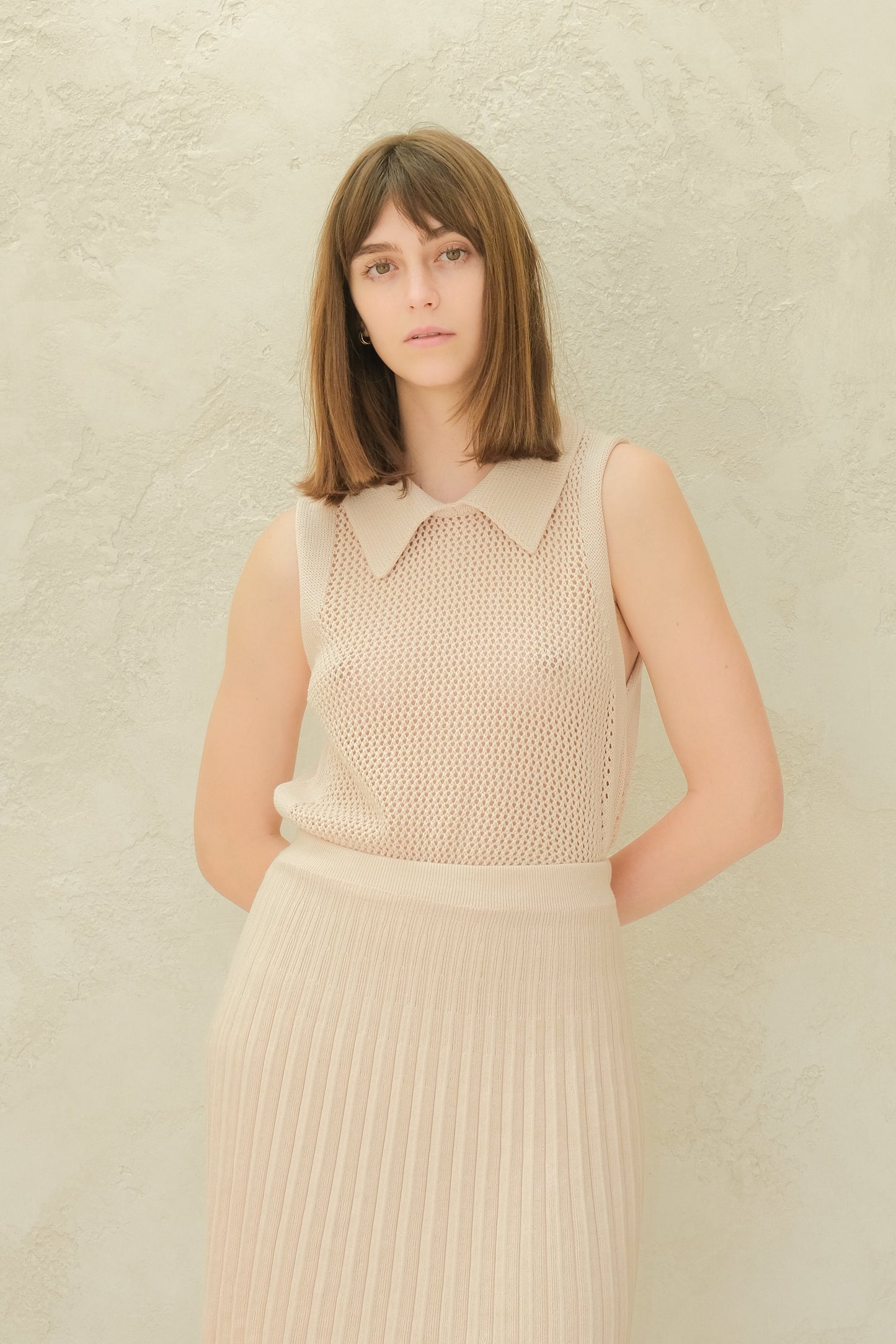 Beige Fine Crochet Polo Tank Top paired with matching skirt. Sustainable luxury knitwear in extrafine merino wool by Lèmme.
