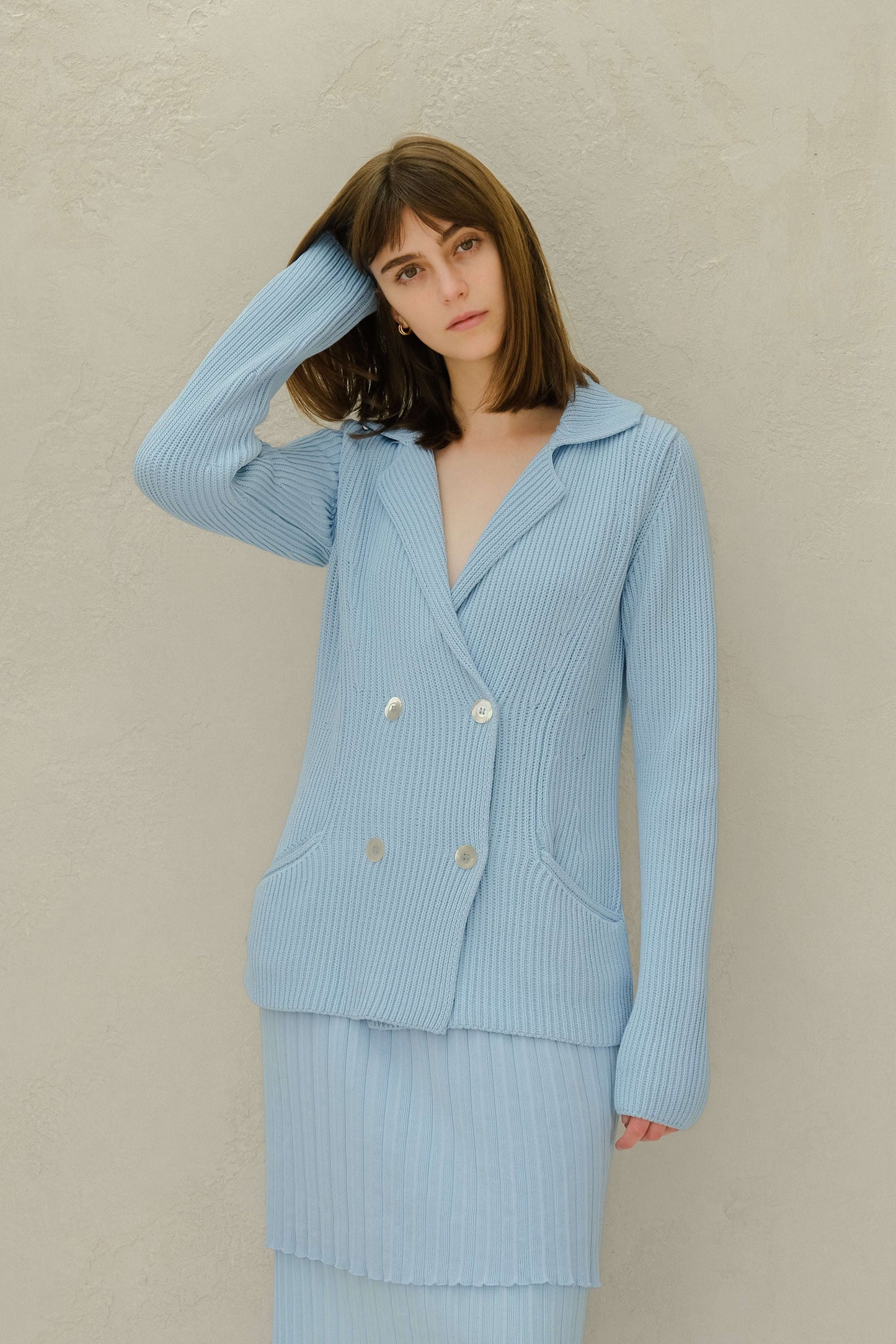 Light blue Fine Cotton Double Breasted Knit Jacket with mother of pearl buttons, styled with matching ribbed skirt. Italian-made outerwear from HenryPawHaven.