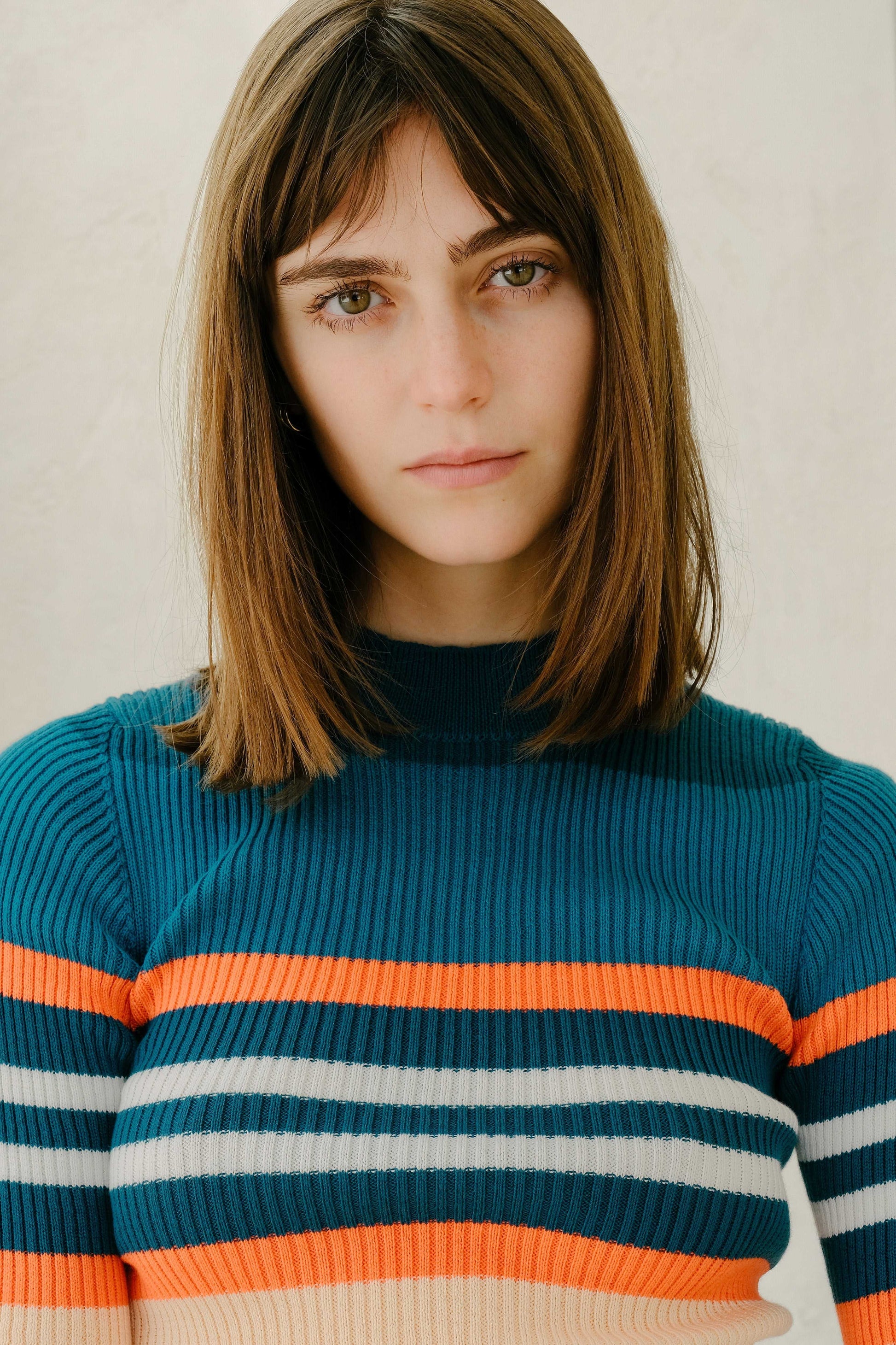 Detailed view of striped ribbed Pima cotton t-shirt in teal and orange, highlighting breathable knitwear design by HenryPawHaven.