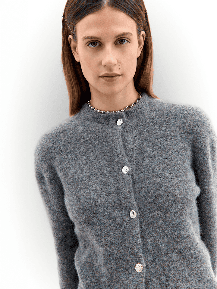 Close-up of grey Women's Fortuna Cardigan with pearl-style buttons, showcasing sustainable Italian knitwear craftsmanship and texture.