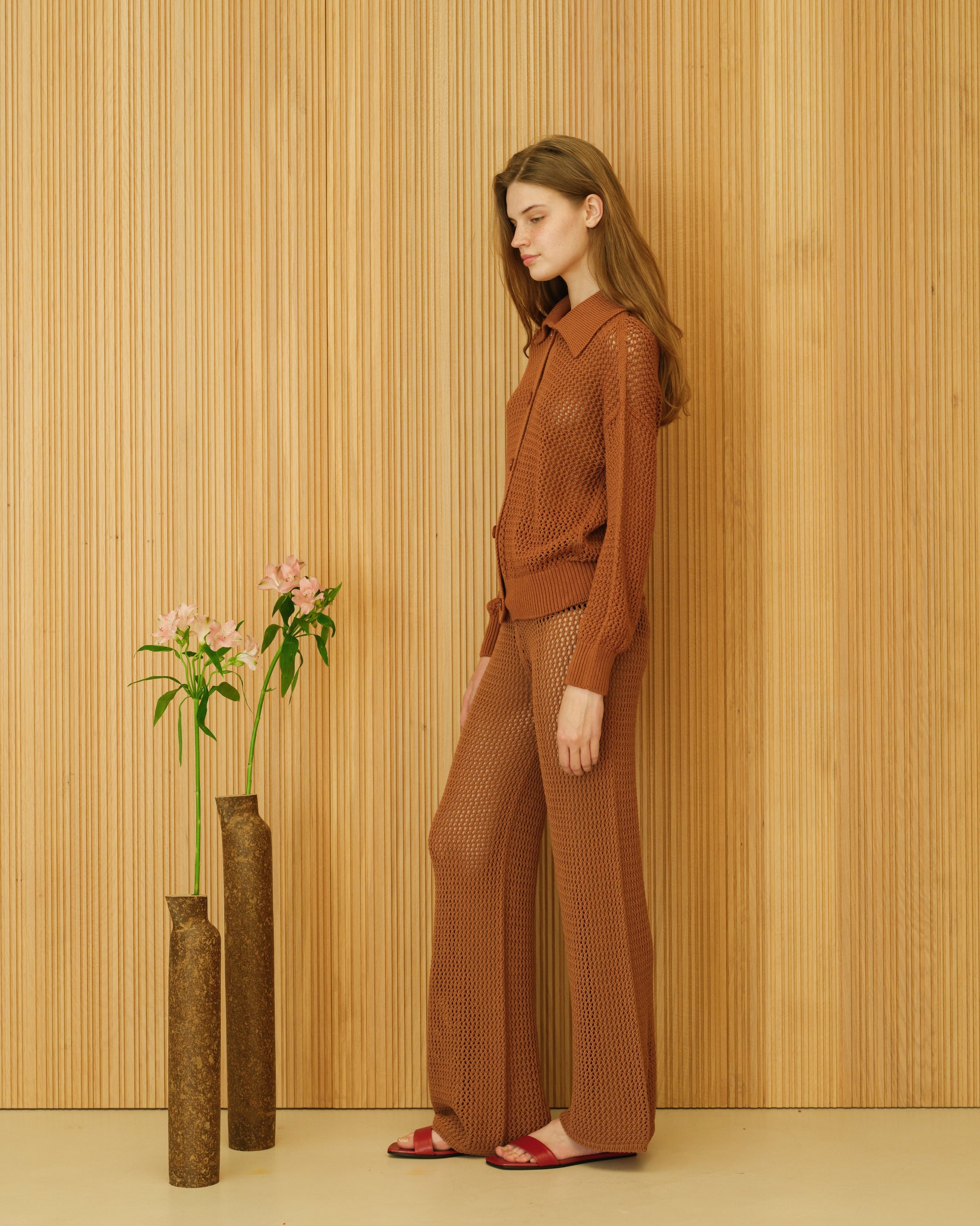 Side view of Fine Cotton Crochet Polo Cardigan by Lèmme in rust brown. Premium Italian knitwear with openwork crochet design and polo collar.