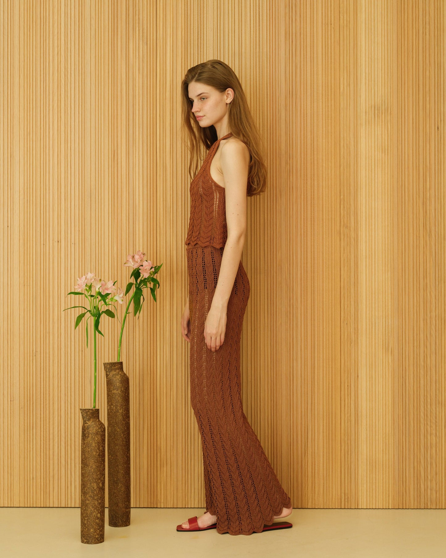 Side view of rust brown crochet halter top in fine cotton knitwear, highlighting breathable texture and sustainable summer elegance.