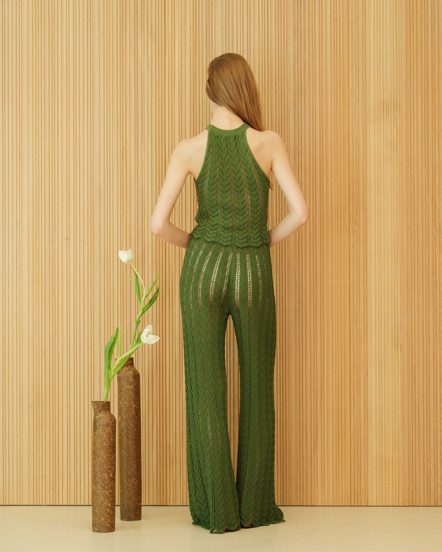 Back view of green fine cotton crochet halter top with zig zag knitwear design. Lightweight and breathable for sustainable summer styling.