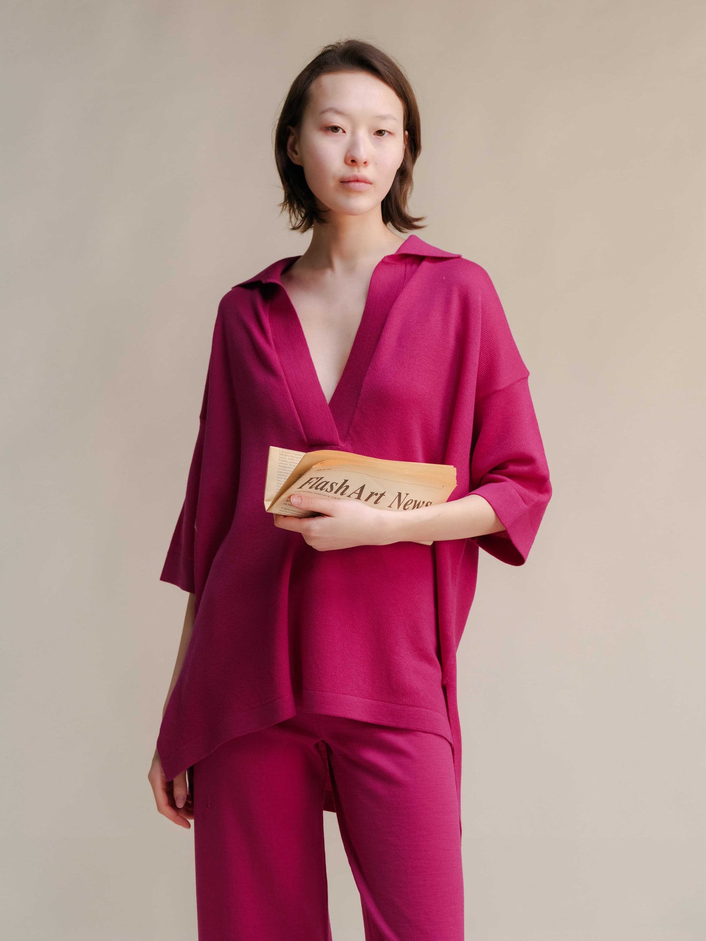 Fuchsia Extra Fine Merino Wool Maxi Polo with deep V-neck and relaxed tailoring, ideal for bold, sustainable fashion statements.