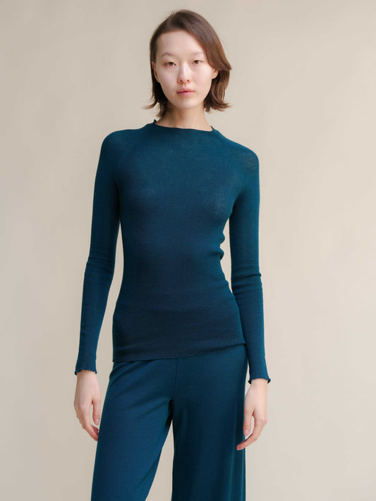 Slim fit ribbed crewneck in teal extra fine merino wool, seamless and breathable knitwear top for women. Ideal for layering or standalone wear.