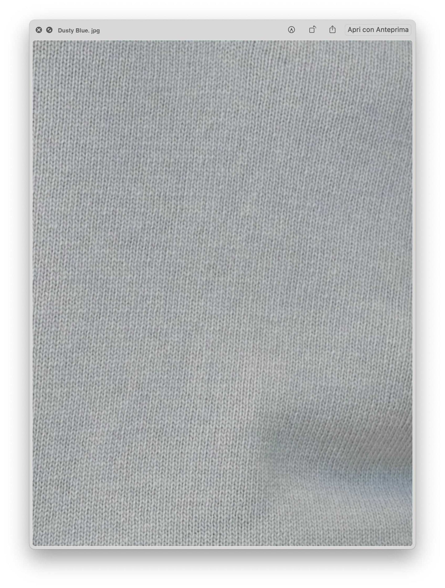 Close-up of dusty blue cashmere wool blend knit fabric showcasing fine Italian craftsmanship and premium texture for luxury outerwear.