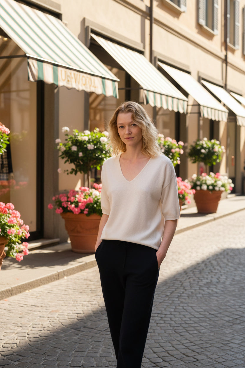 Woman wearing a white blouse and black pants in an Italian shopping street