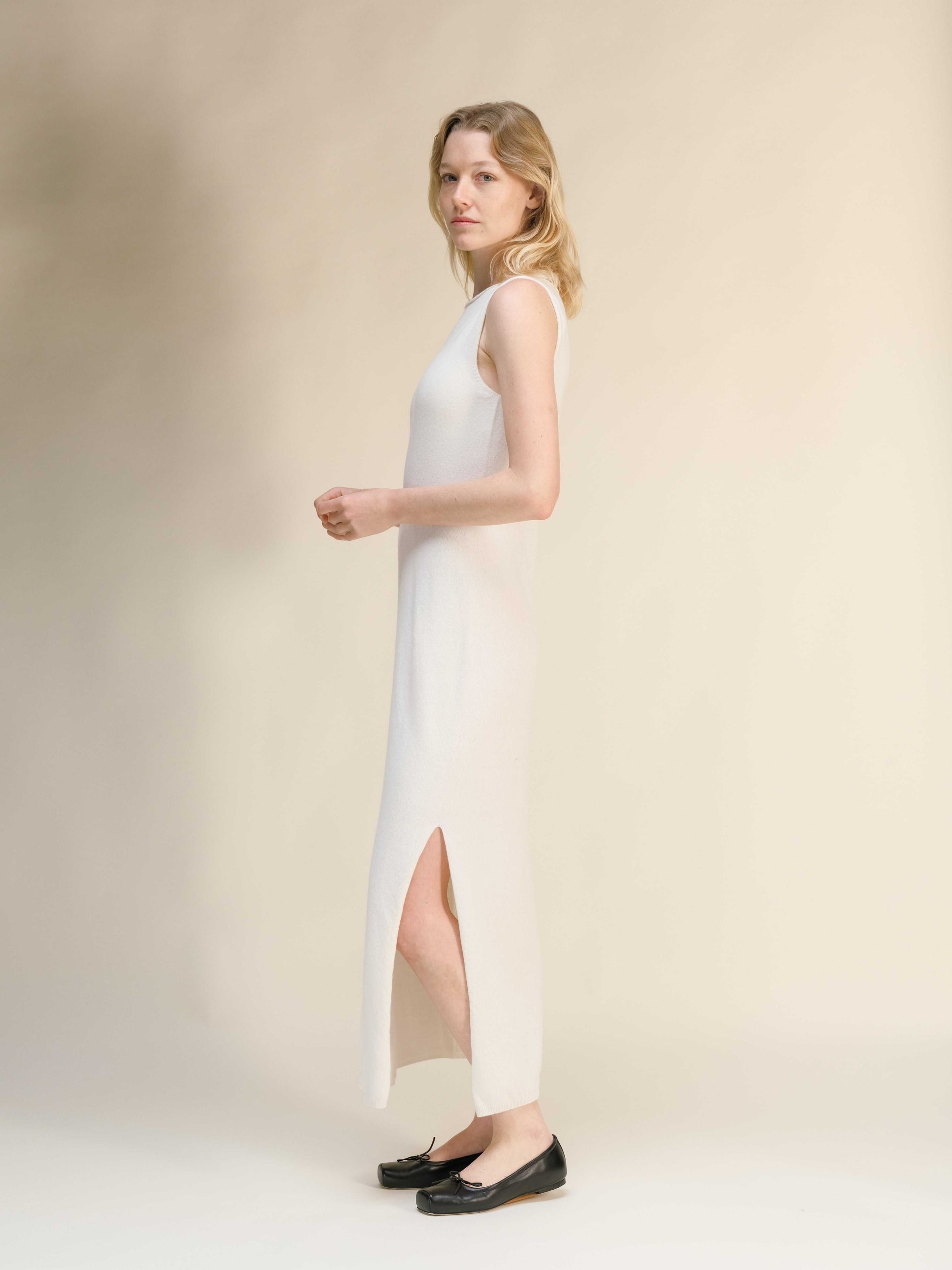 Ivory Cashmere Boat Neck Sleeveless Dress in seamless Italian knitwear, featuring a side slit and luxurious soft texture.