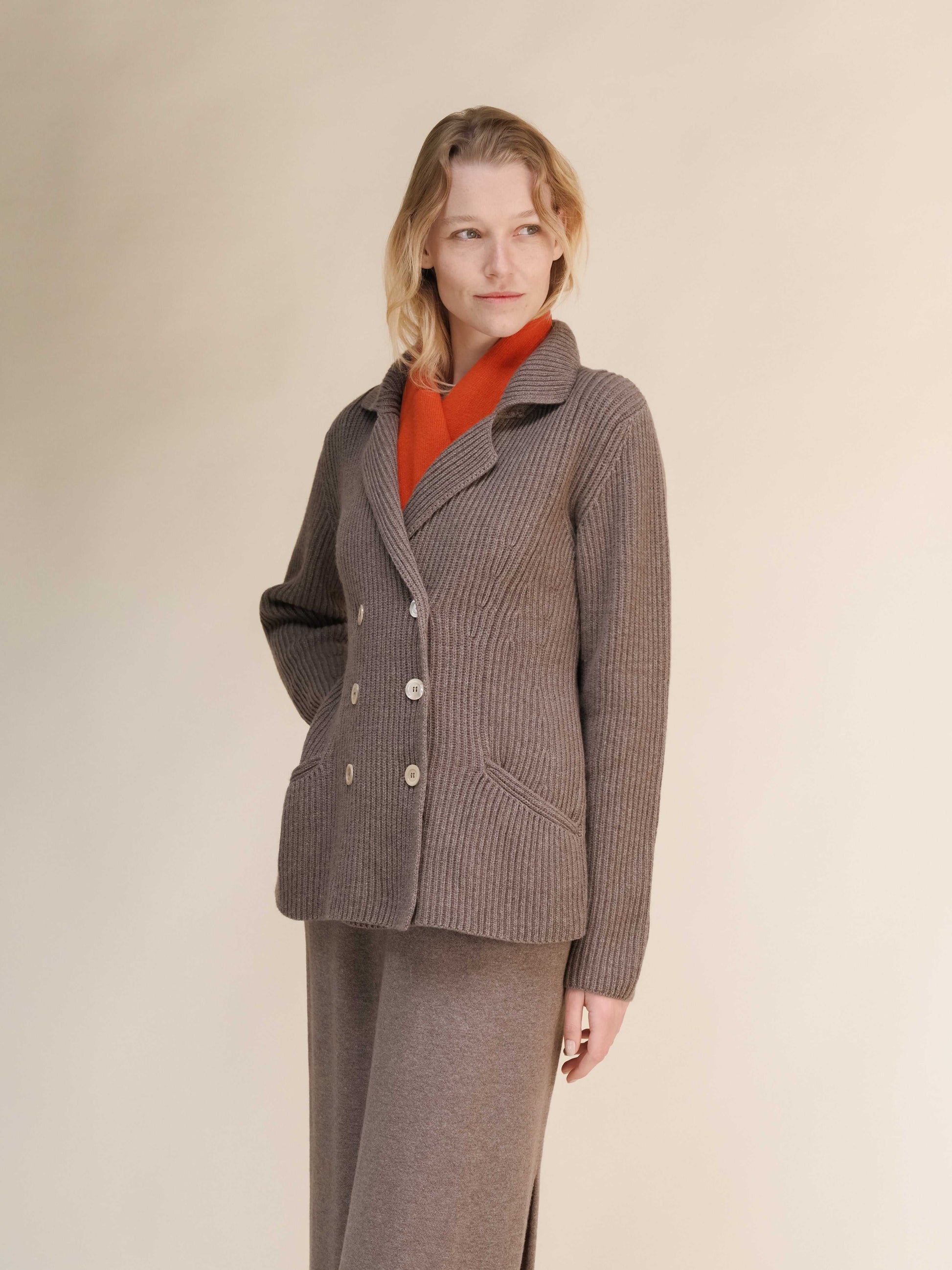 Side view of taupe cashmere wool blend jacket with orange inner layer, showcasing Italian craftsmanship and double breasted design.
