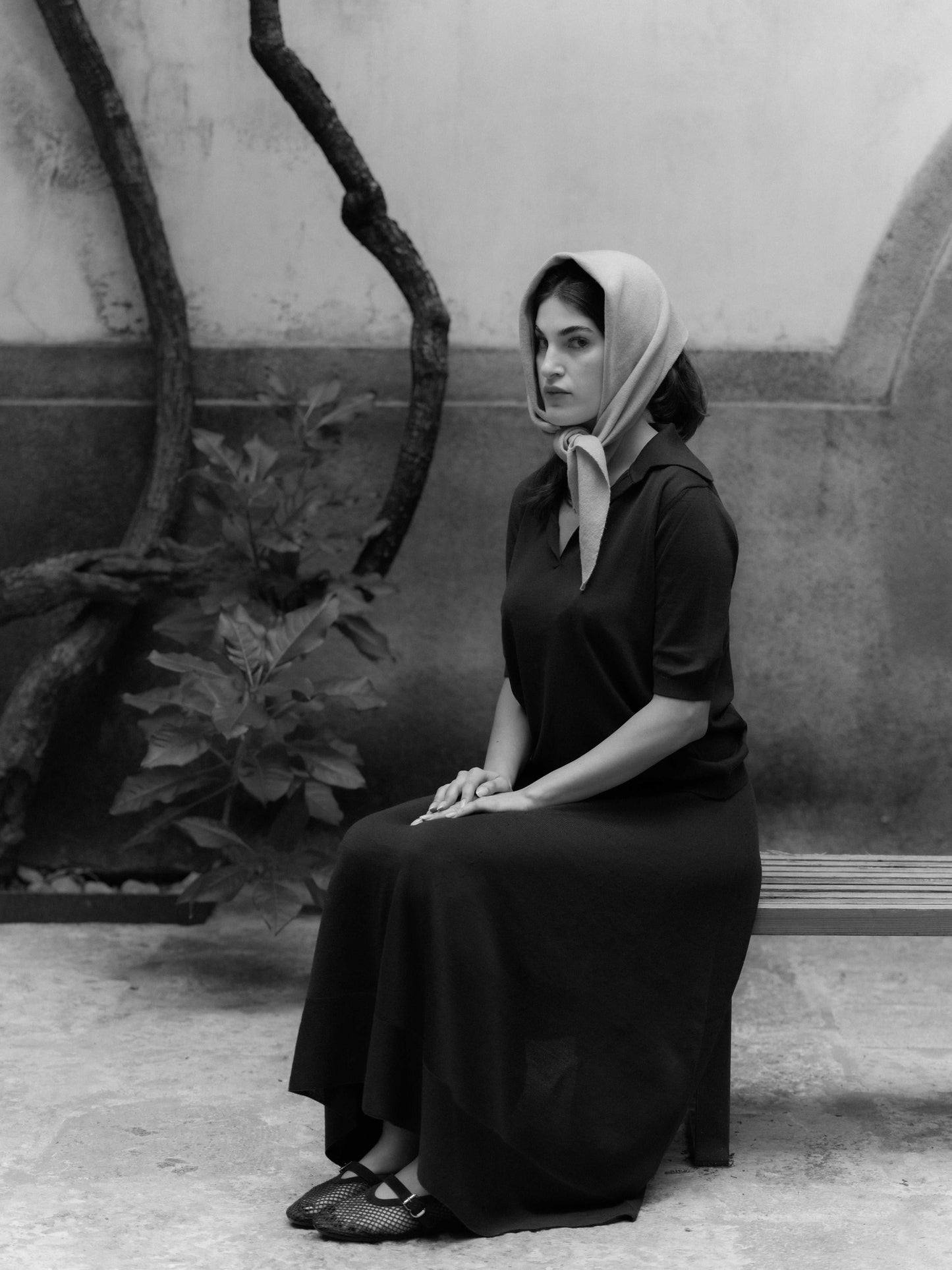 Cashmere Mix Triangle Scarf worn as a headscarf in neutral tone. Elegant Italian knitwear for timeless, versatile styling.