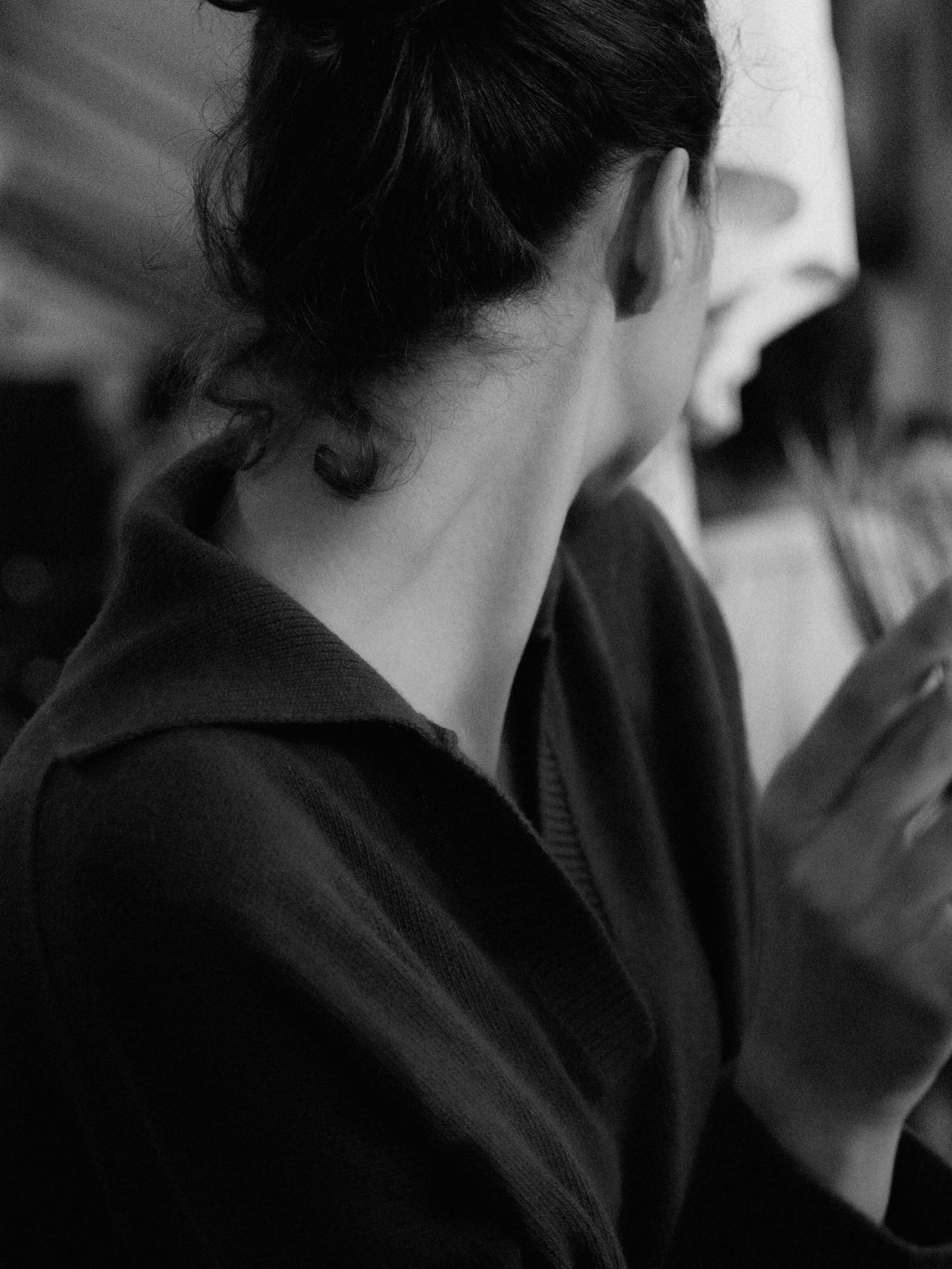 Woman wearing dark Cashmere-Wool Blend Relaxed Polo by HenryPawHaven, showcasing the soft collar and Italian craftsmanship in a candid moment.