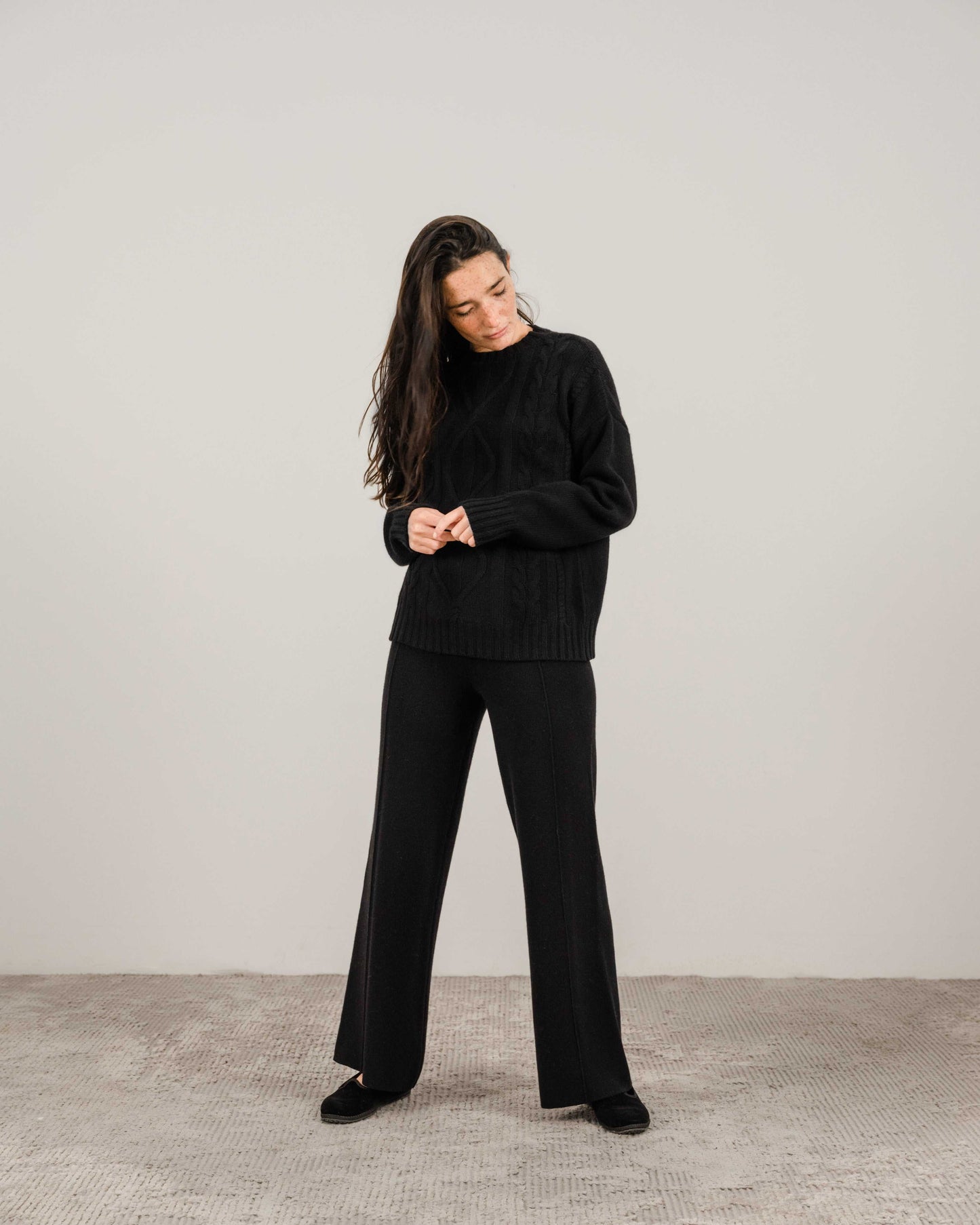 Black Cashmere Mix Cable Knit Sweater with wide-leg pants. Timeless sustainable knitwear from HenryPawHaven for refined comfort.