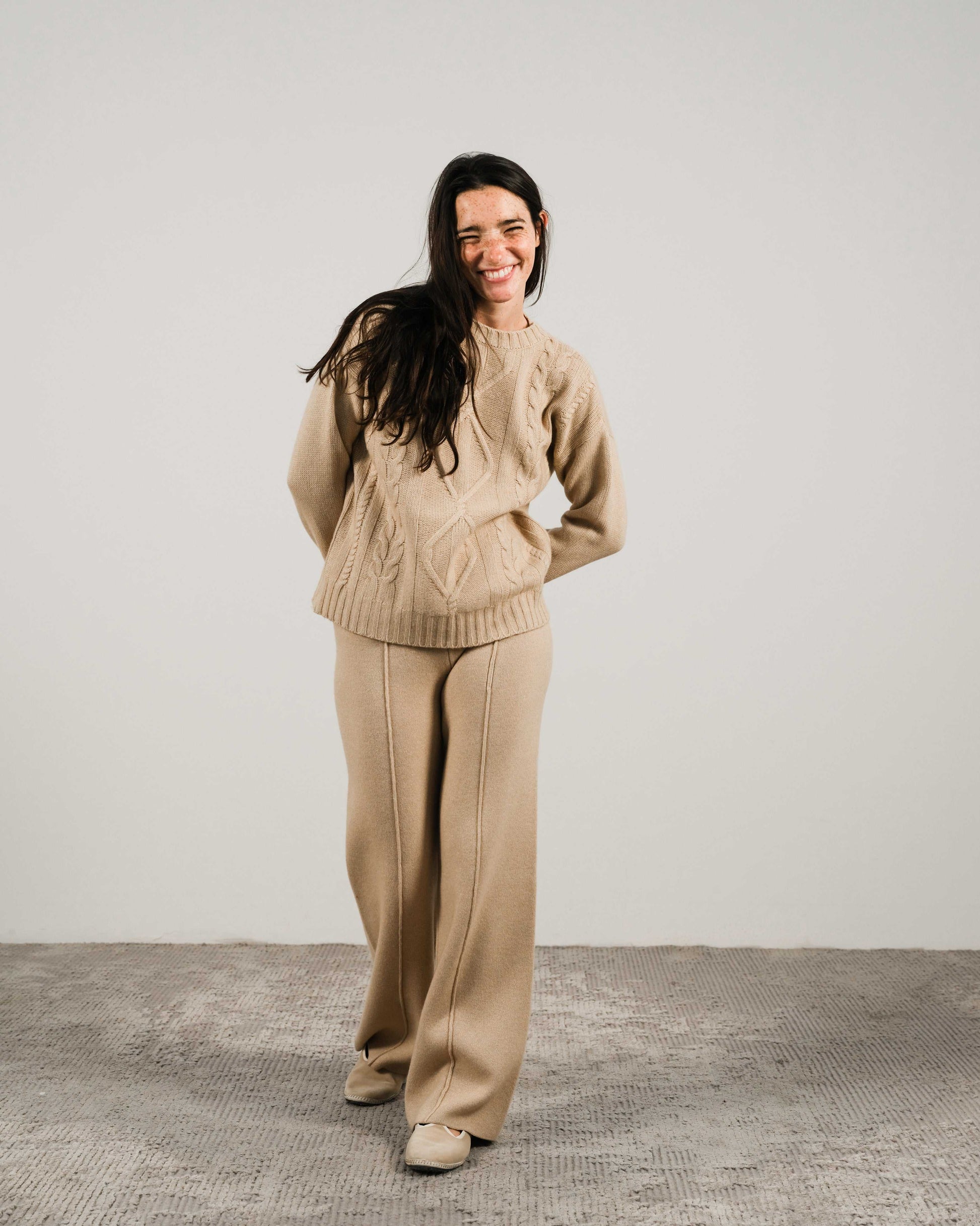 Beige Cashmere Mix Cable Knit Sweater styled with matching pants, showcasing durable yarn blend and relaxed fit for cozy sustainable fashion.