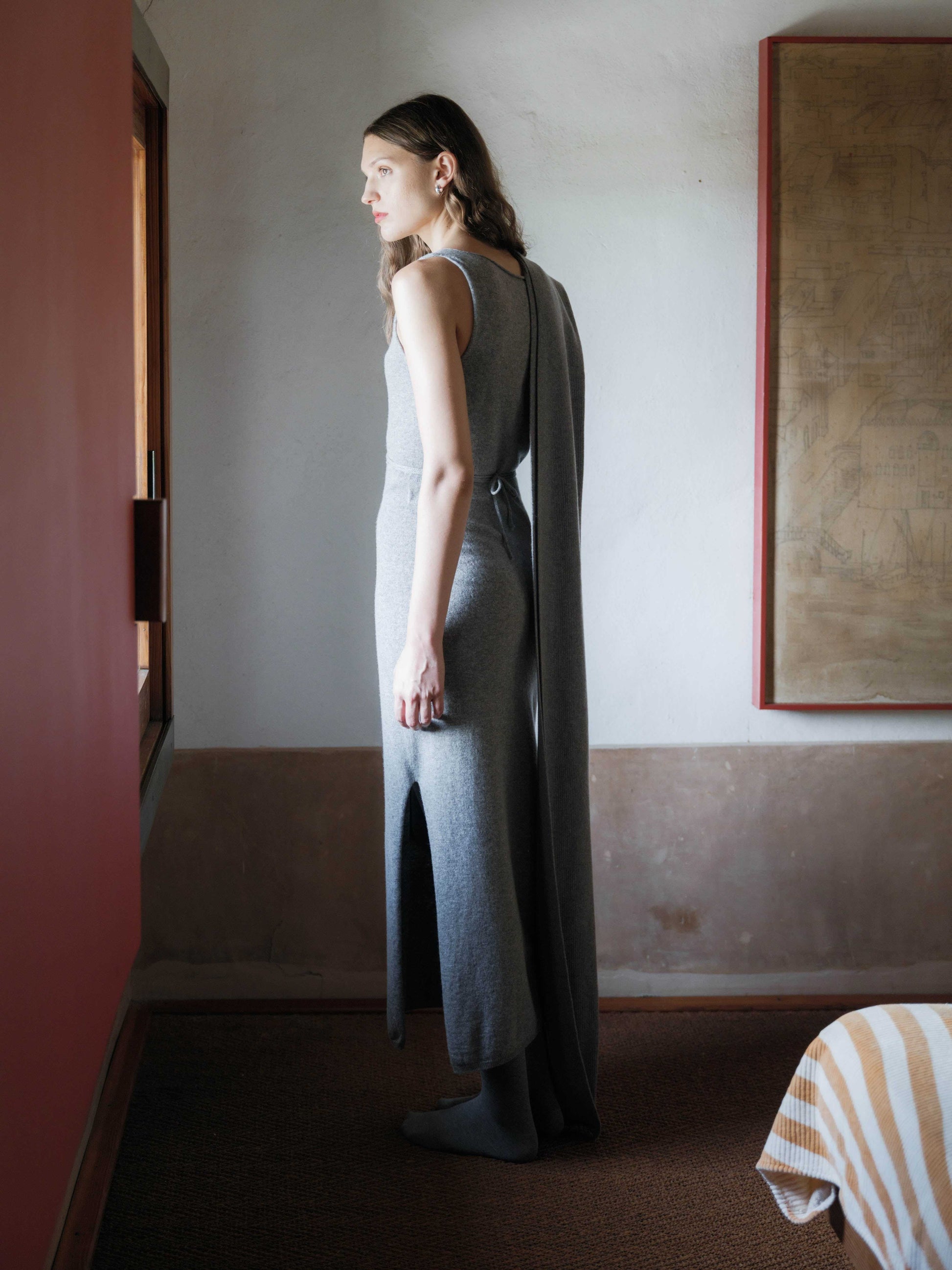 Back view of grey Cashmere Boat Neck Sleeveless Dress with matching scarf, Italian 3D-knit design and elegant side slit.
