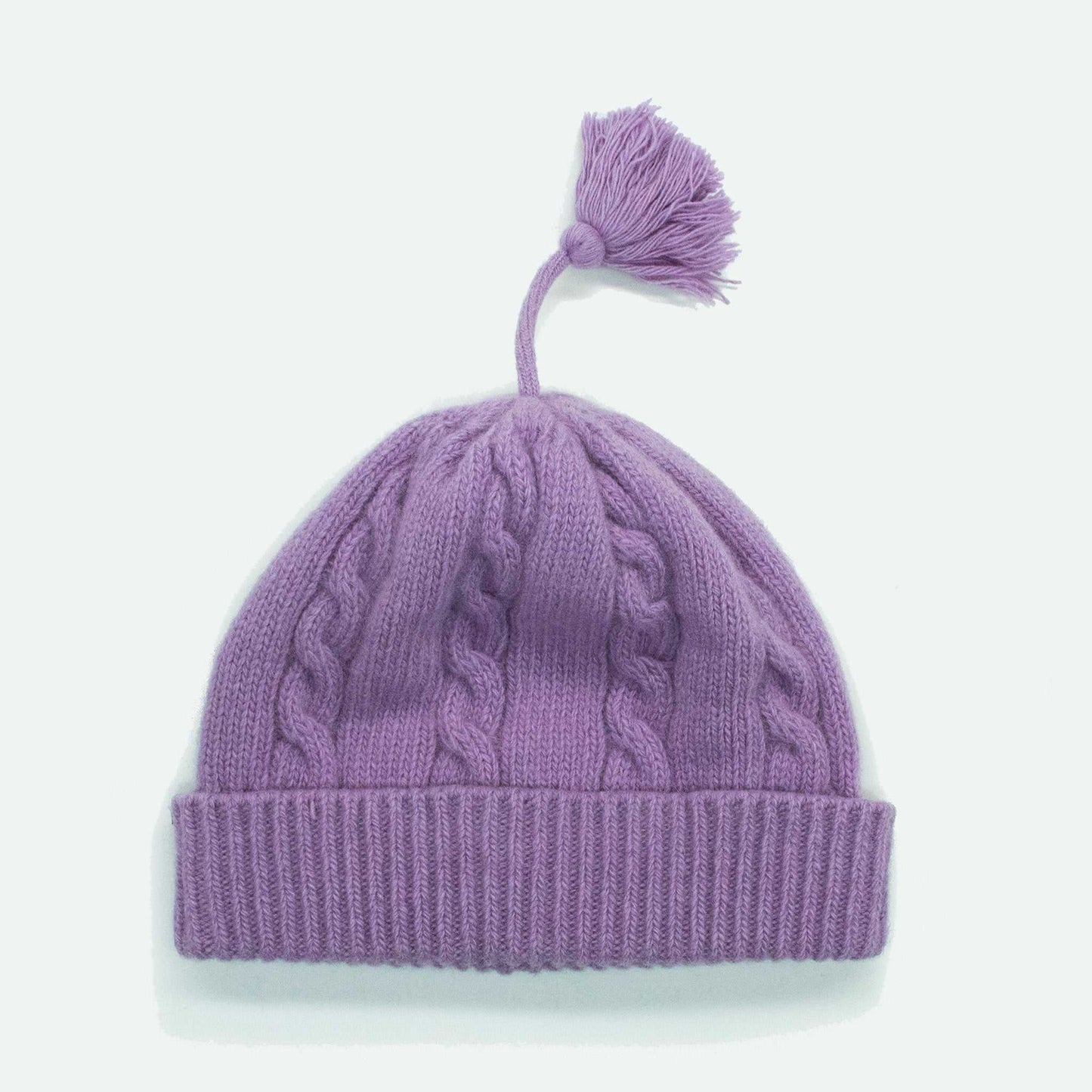 Portolano Baby Cashmere Hat in purple with cable knit texture and tassel. Ultra-soft 100% cashmere hat designed for baby comfort and warmth.