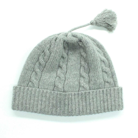 Portolano Baby Cashmere Hat in grey featuring a cozy cable knit pattern and tassel. Premium baby hat made from 100% soft cashmere.