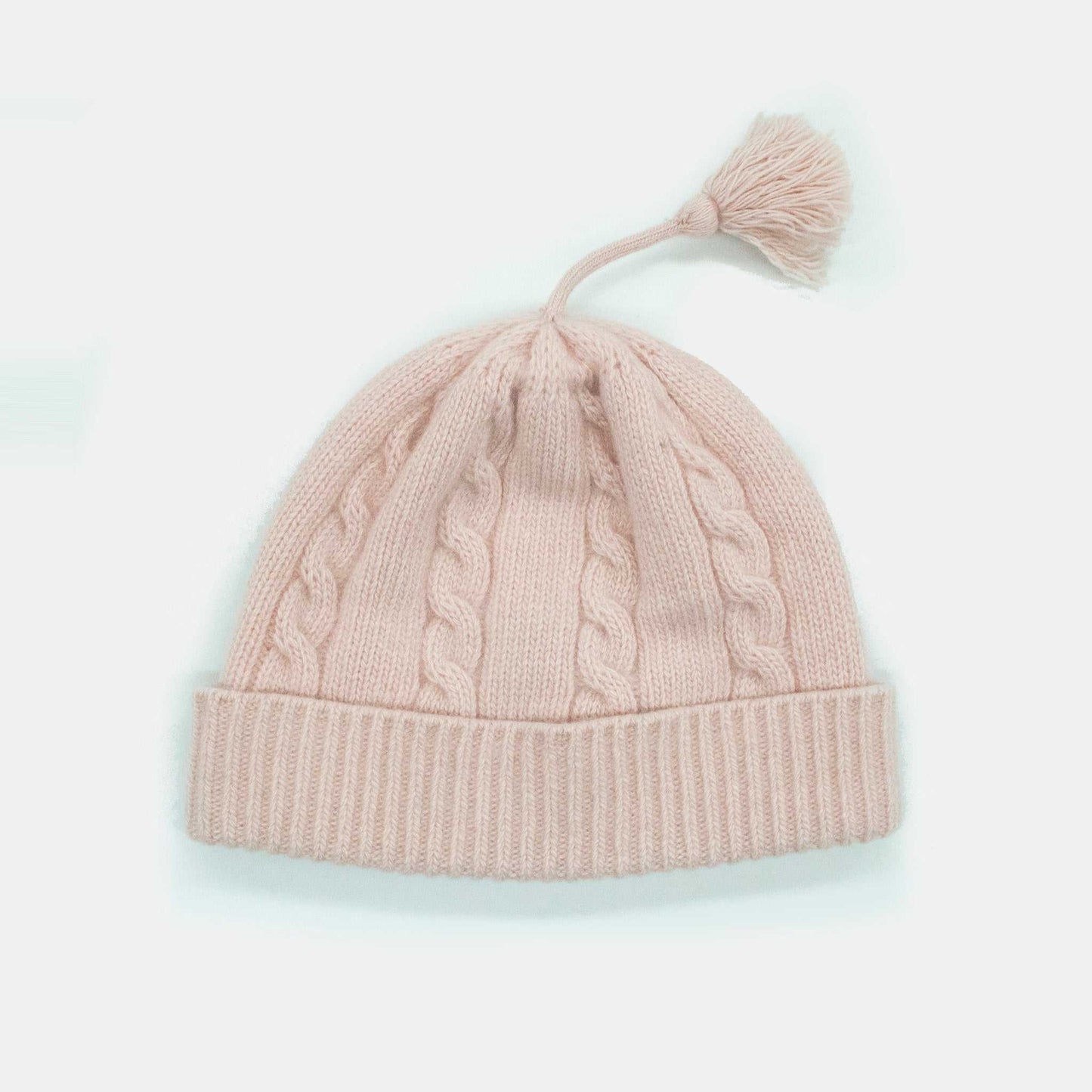 Portolano Baby Cashmere Hat in pink with cable knit detailing and tassel. Soft and stylish 100% cashmere infant hat for cooler weather.