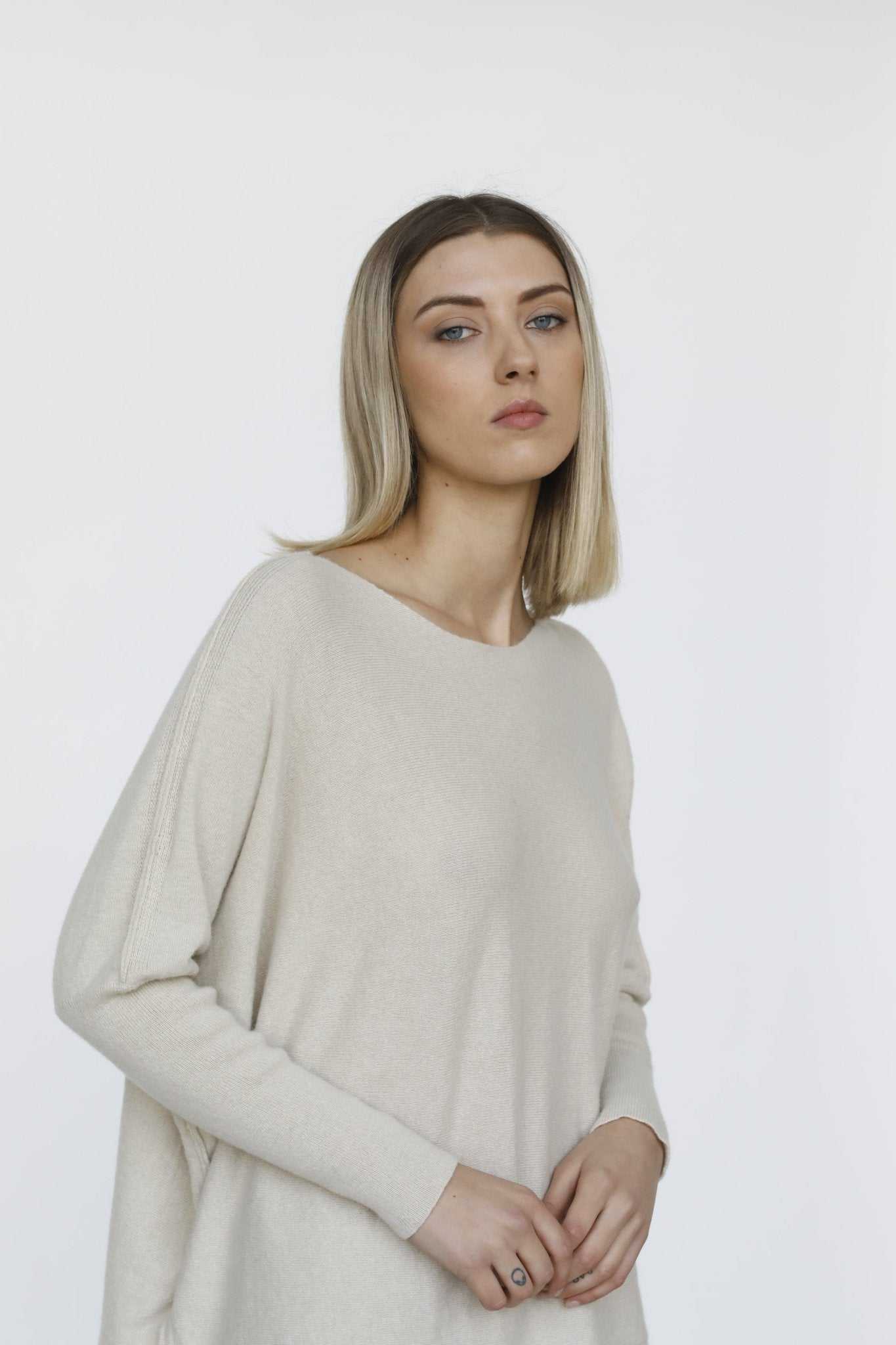Margot Box-Fit Wool Sweater by Tenné in cream, featuring wide neckline and long sleeves, styled for a relaxed fit in eco-friendly wool.