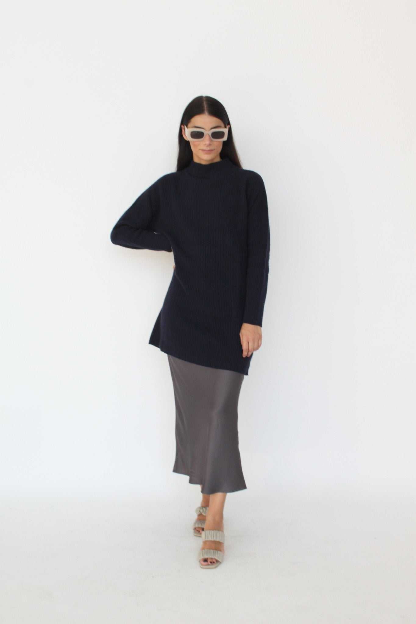 Cashmere Blend Knit Dress - Agnese by Tenné in navy, featuring ribbed knit texture, turtleneck, and long sleeves. Styled with a satin skirt for fall fashion.