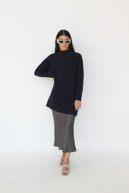 Cashmere Blend Knit Dress - Agnese by Tenné in navy, featuring ribbed knit texture, turtleneck, and long sleeves. Styled with a satin skirt for fall fashion.