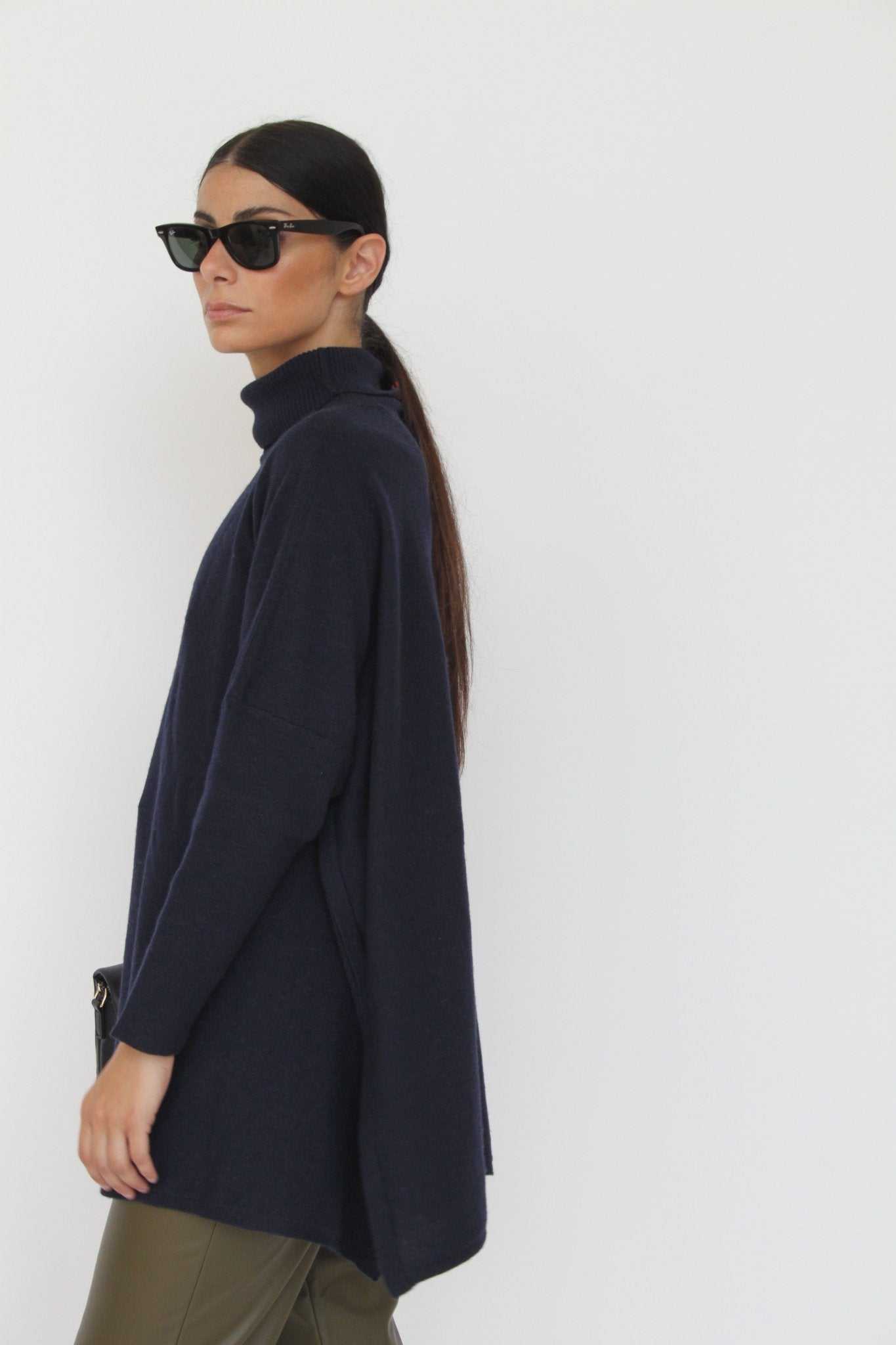 Side view of Amalia Cashmere Blend Turtleneck Sweater in Anthracite by Tenné, showcasing relaxed silhouette and ribbed turtleneck design.