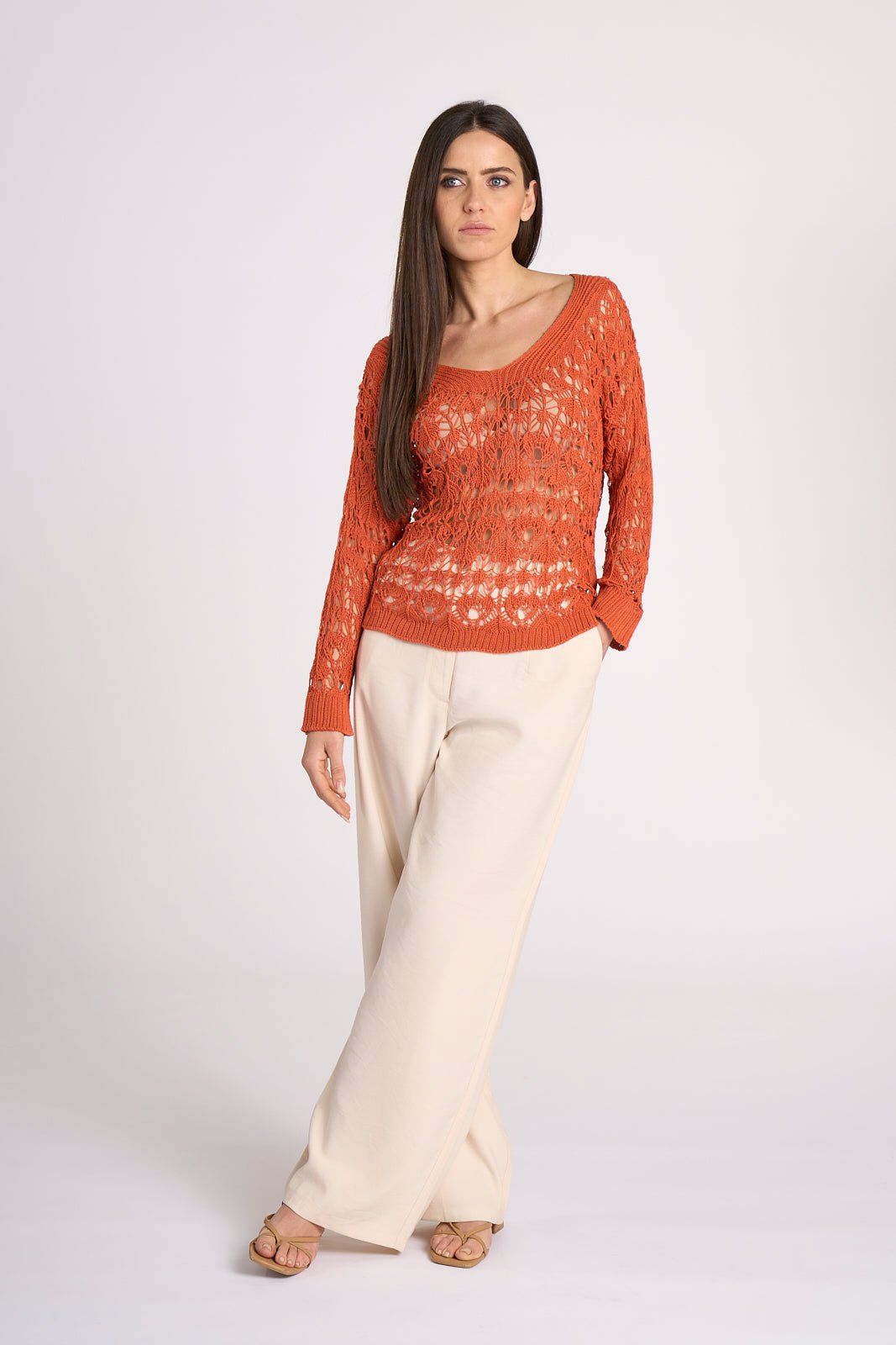 Full-length view of burnt orange Crochet Cotton Top - Elisa by Tenné, paired with wide-leg cream pants for a relaxed resort wear outfit.