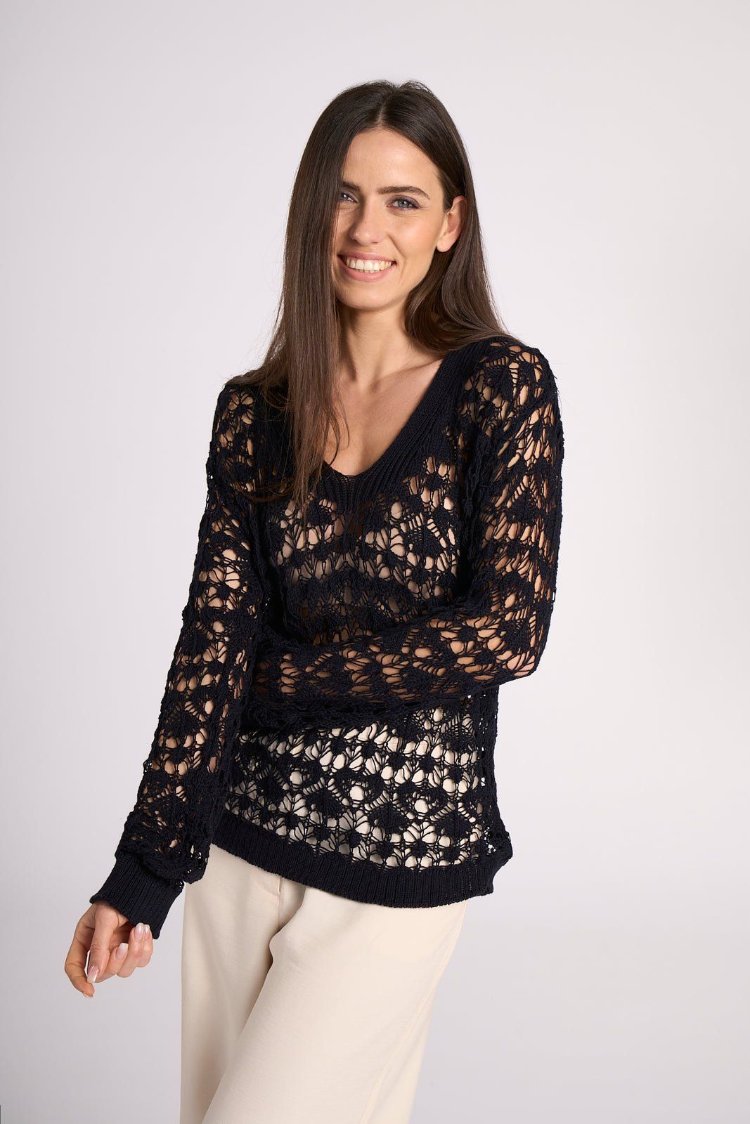 Crochet Cotton Top - Elisa by Tenné in navy blue with V-neck and long sleeves, styled with cream trousers for spring or summer resort wear.