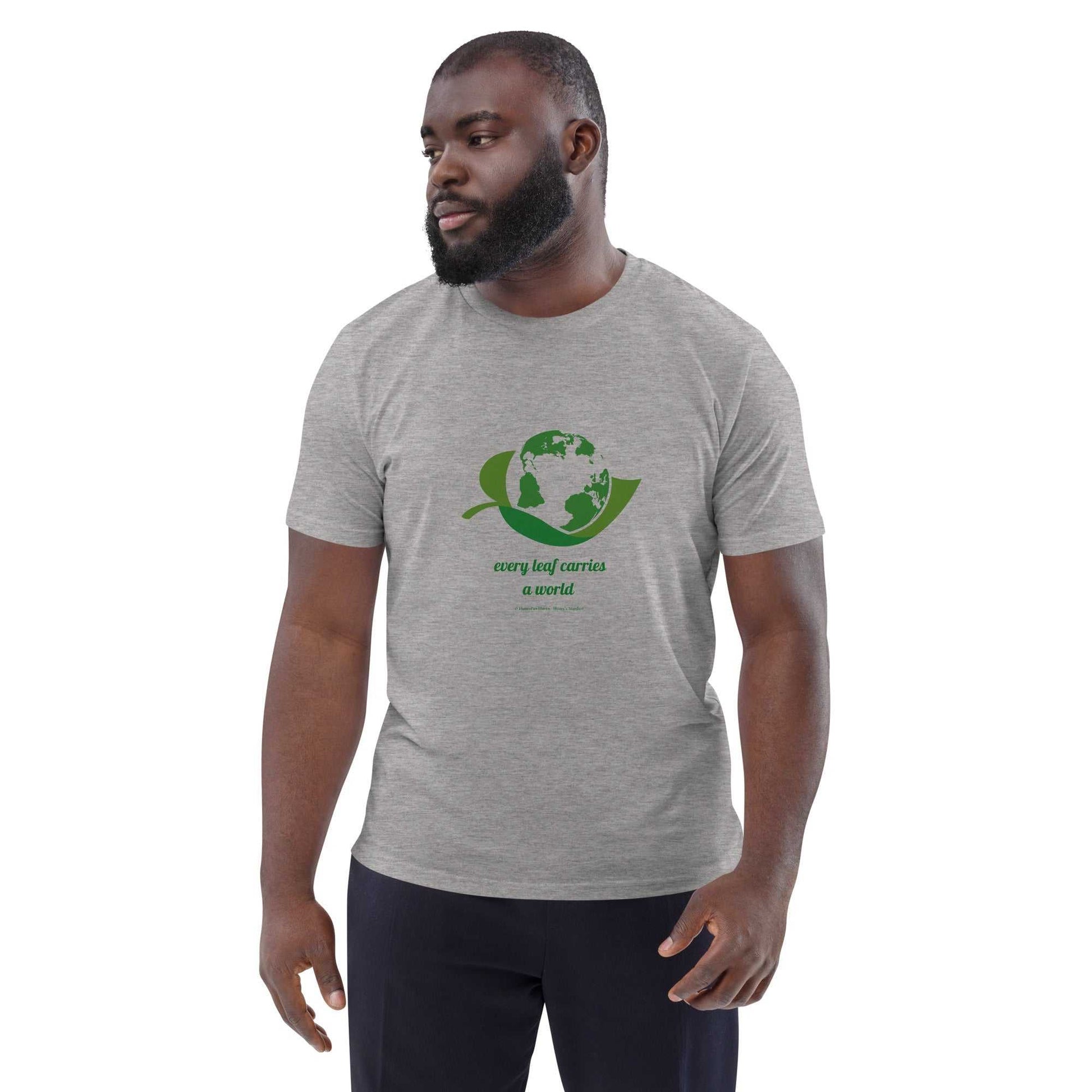 Heather gray Organic Cotton T-Shirt with green leaf and globe design, promoting eco-conscious fashion with 'Every Leaf Carries a World' slogan.