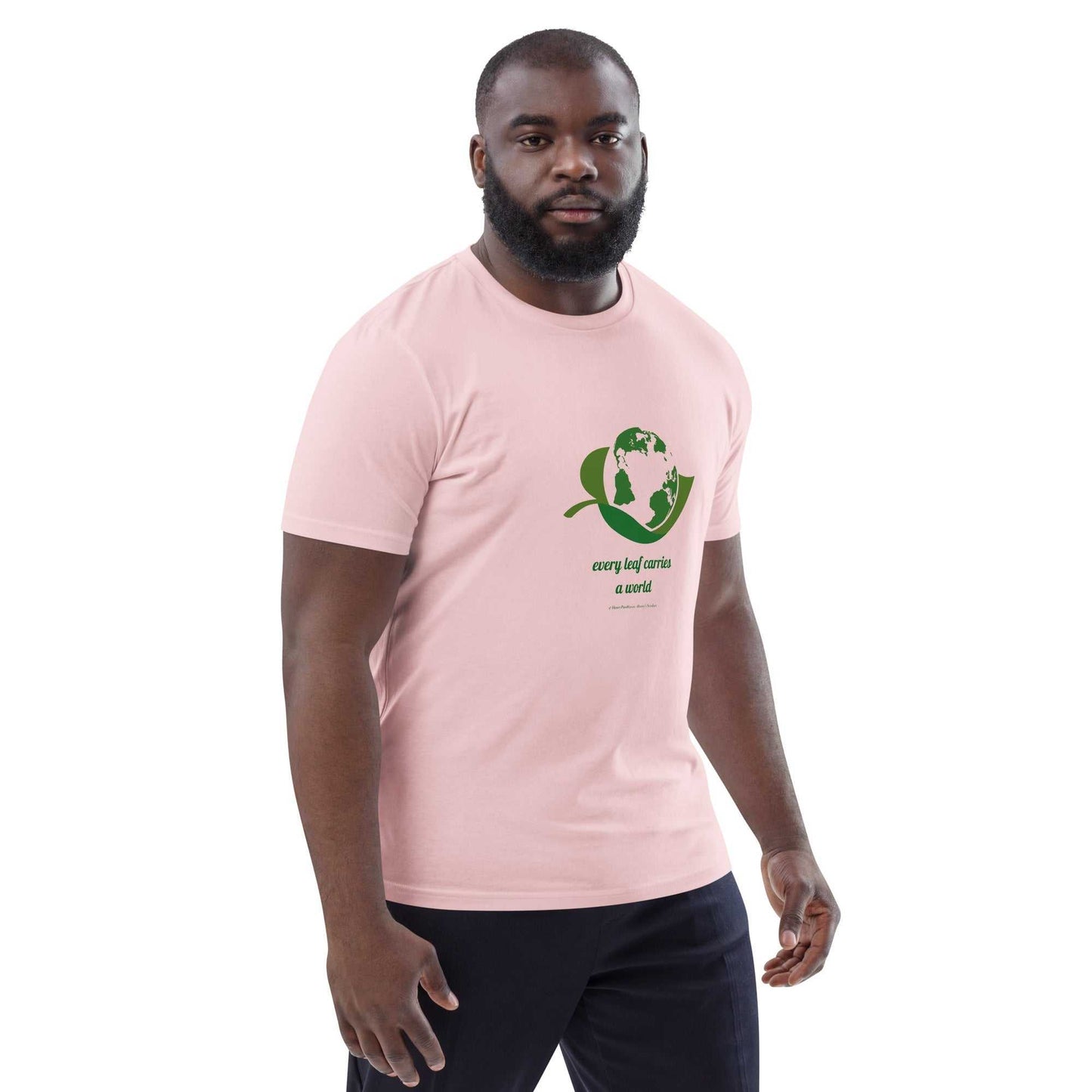 Unisex light pink Organic Cotton T-Shirt featuring green environmental artwork and 'Every Leaf Carries a World' text, made for eco-conscious style.